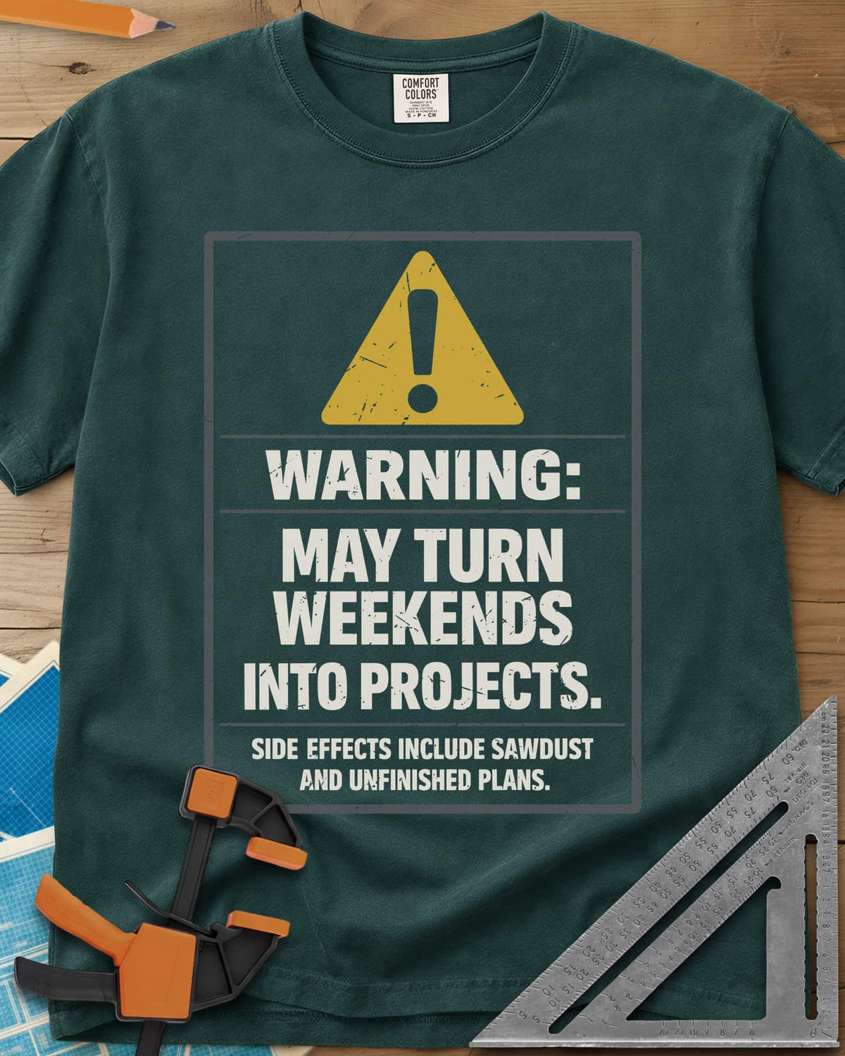 Warning Weekends Into Projects heavyweight tee in Blue Spruce, a hazard-sign panel with a yellow triangle and a side-effects