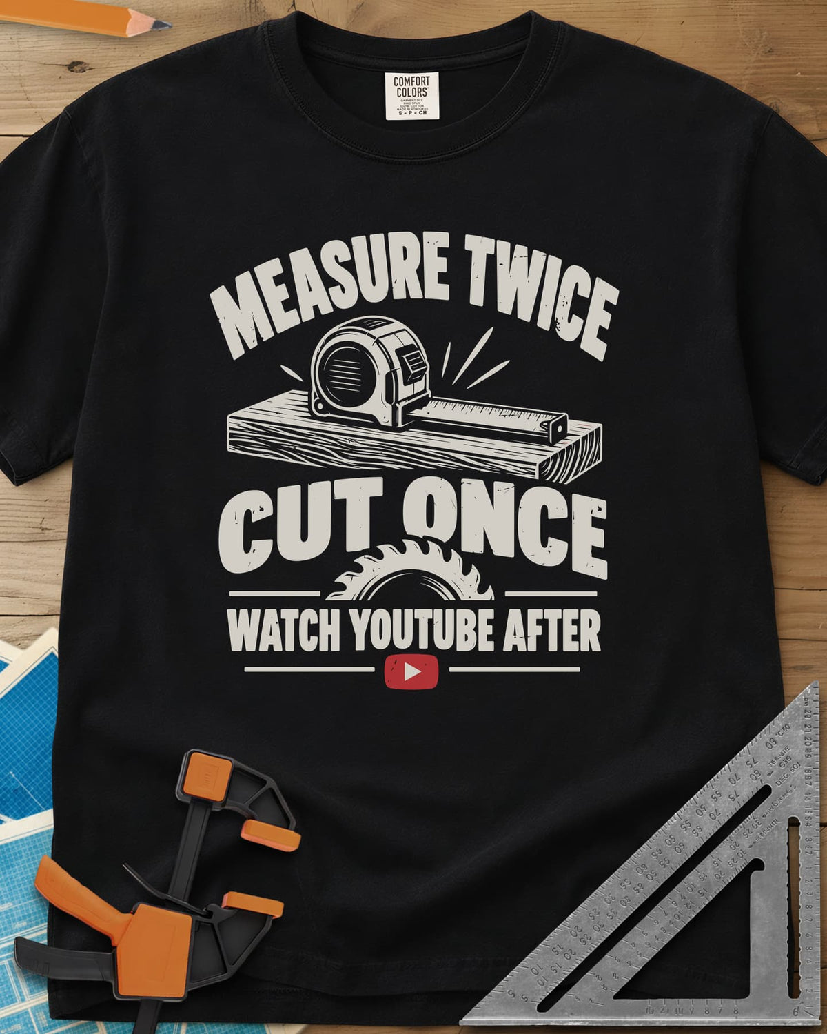 Watch YouTube After heavyweight tee in Black, tape measure on a plank, a saw blade and a red play button