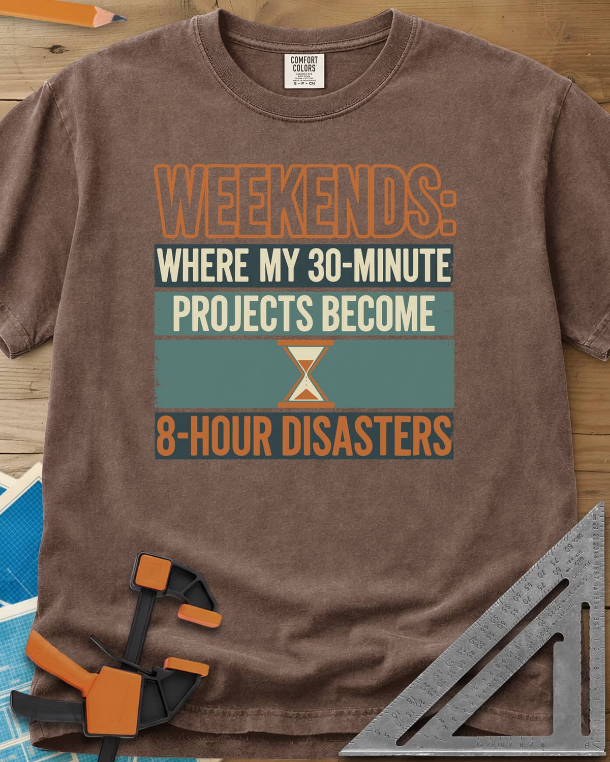 Weekend Disasters heavyweight tee in Espresso, retro striped text blocks around an hourglass