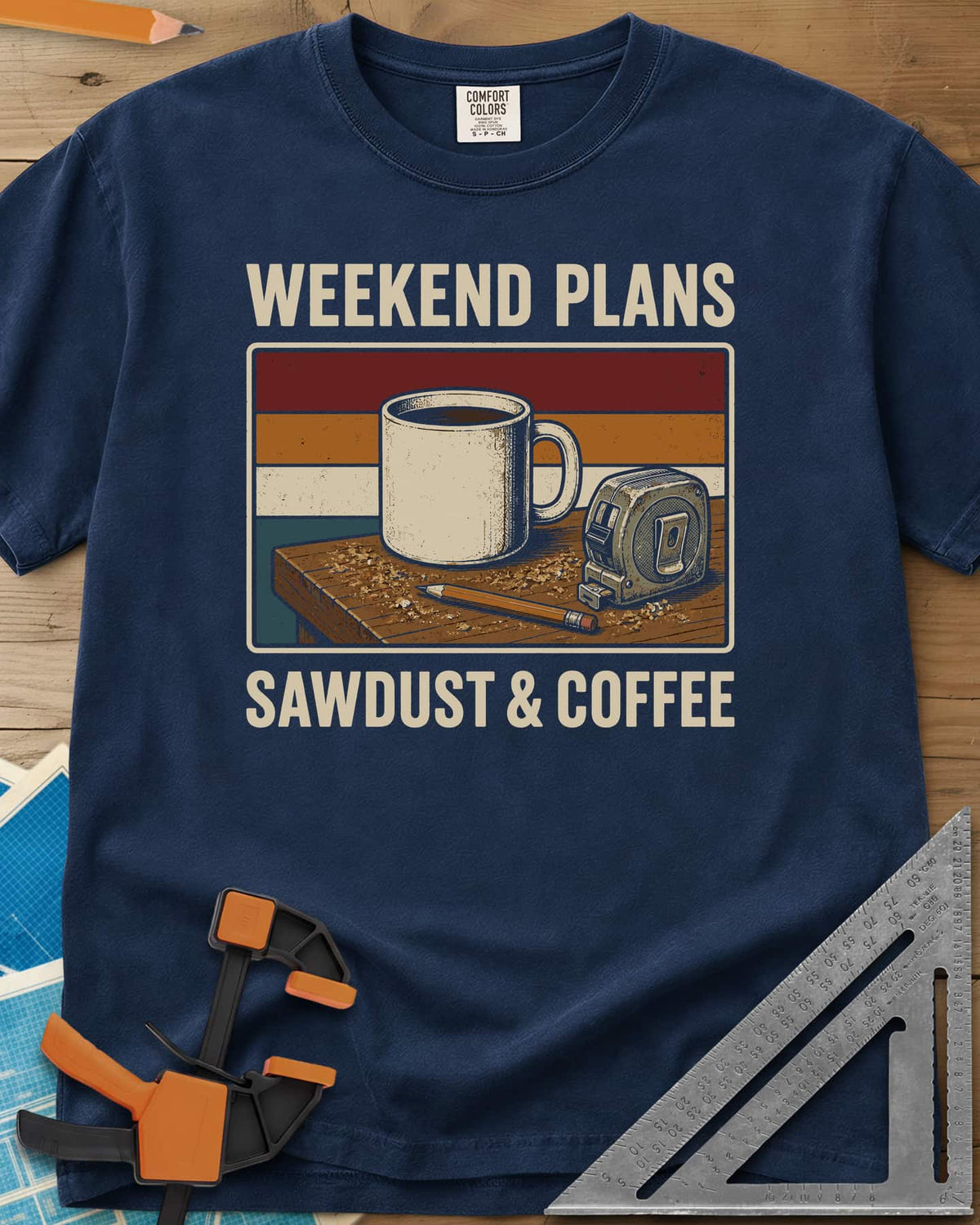 Weekend Plans Sawdust Coffee heavyweight tee in Navy, a coffee mug, tape measure and pencil on a sawdusty bench