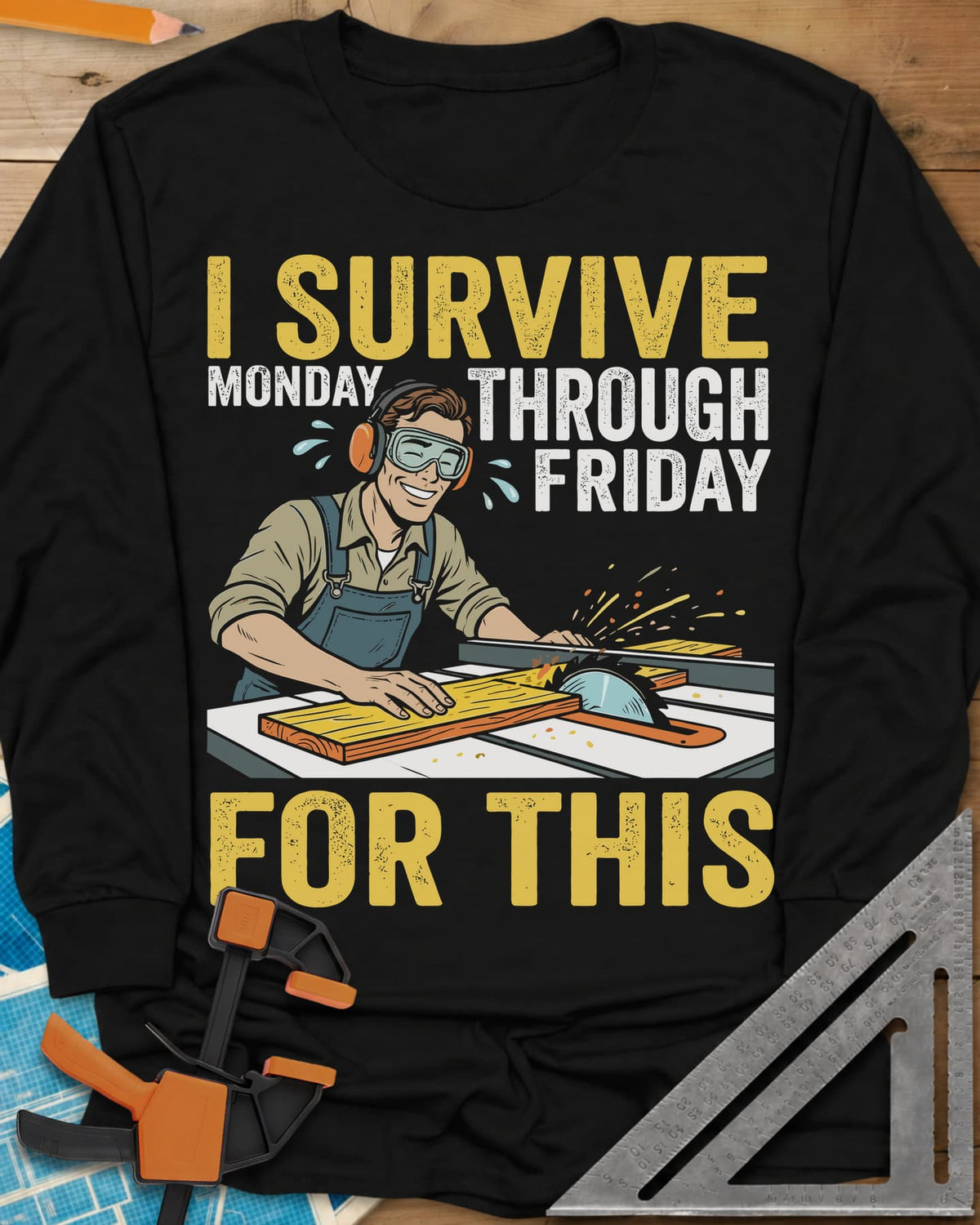 Weekend Reward long sleeve shirt in Black, a smiling woodworker in goggles pushing a board through a table saw