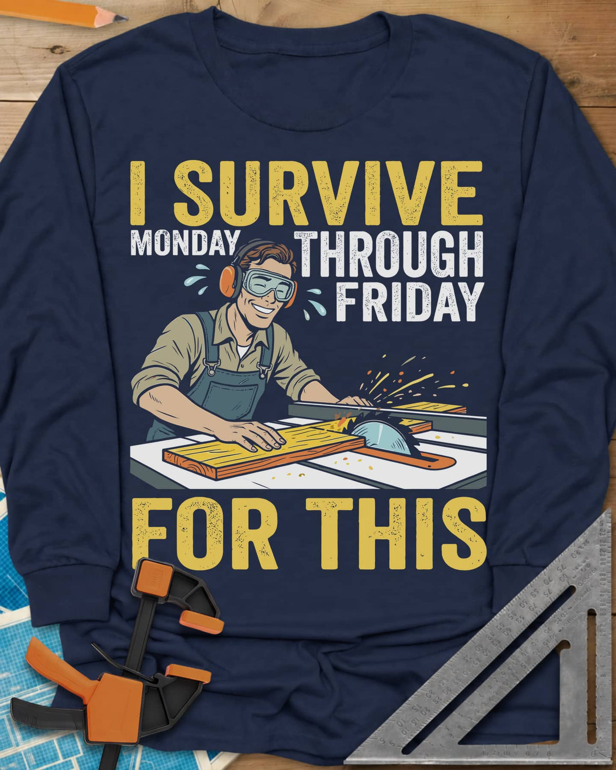 Weekend Reward long sleeve shirt in Navy, a smiling woodworker in goggles pushing a board through a table saw