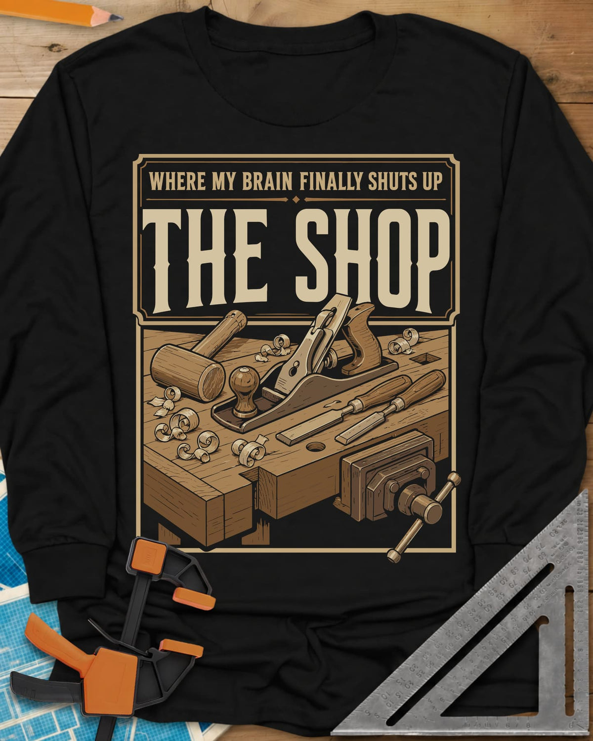 Where My Brain Finally Shuts Up long sleeve shirt in Black, a framed workbench poster with plane, mallet, chisels and vise