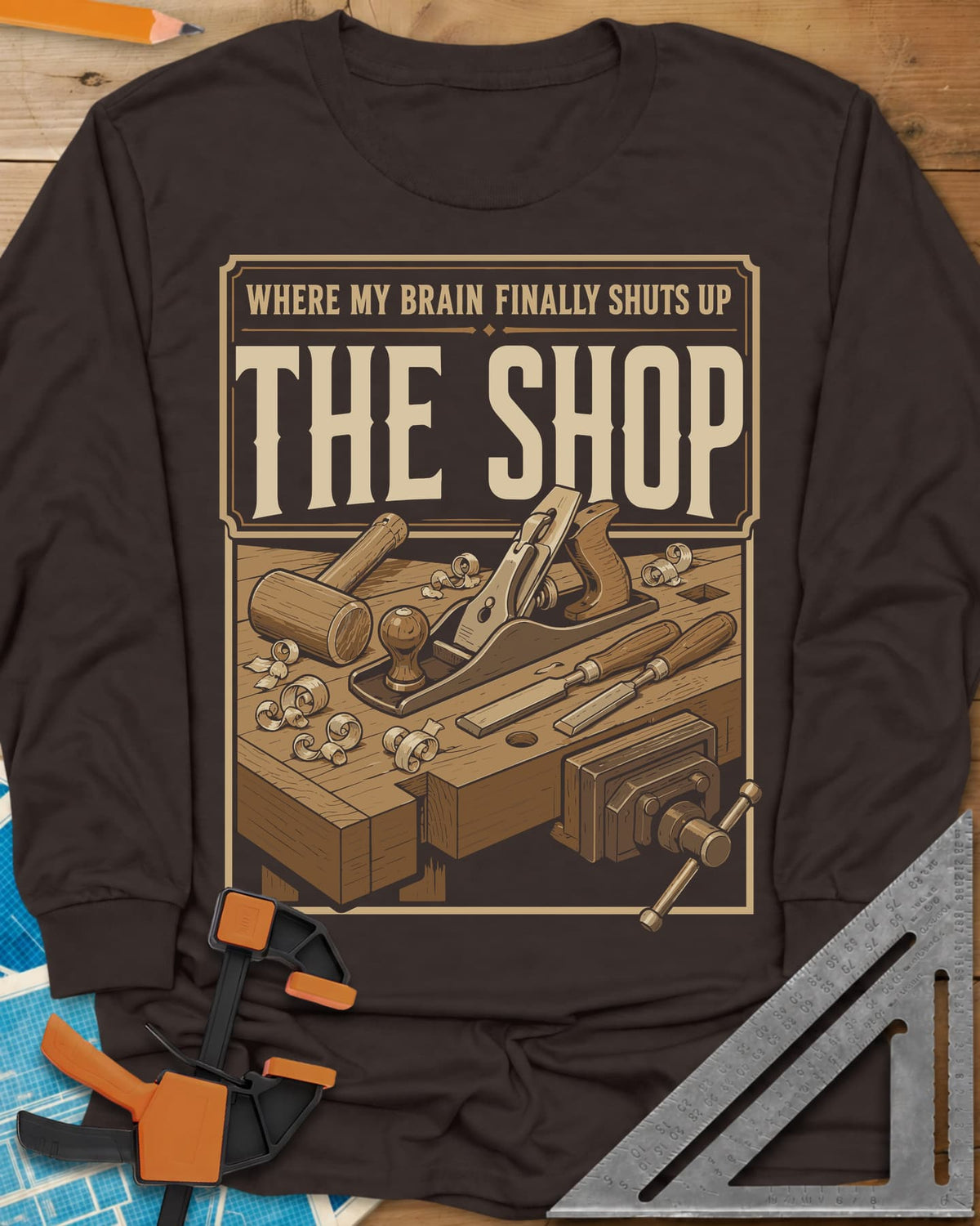 Where My Brain Finally Shuts Up long sleeve shirt in Dark Chocolate, a framed workbench poster with plane, mallet, chisels