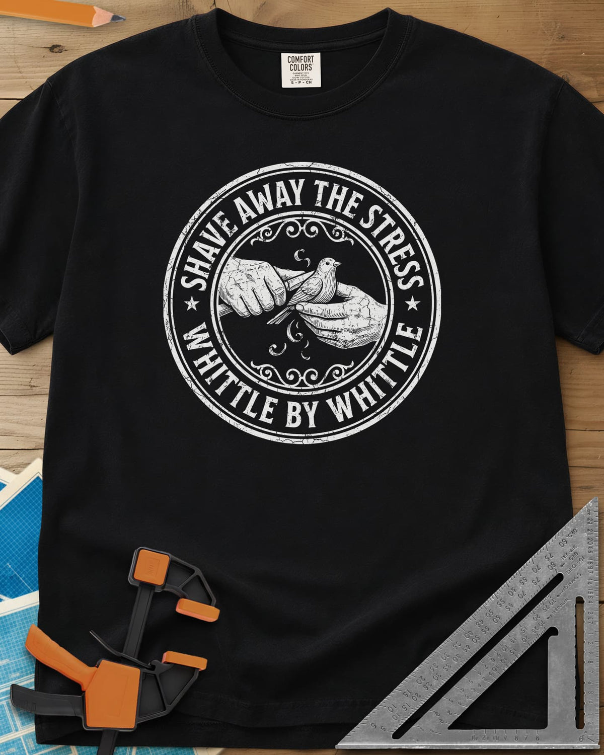Whittle by Whittle heavyweight tee in Black, two hands whittling a small bird inside a round distressed badge