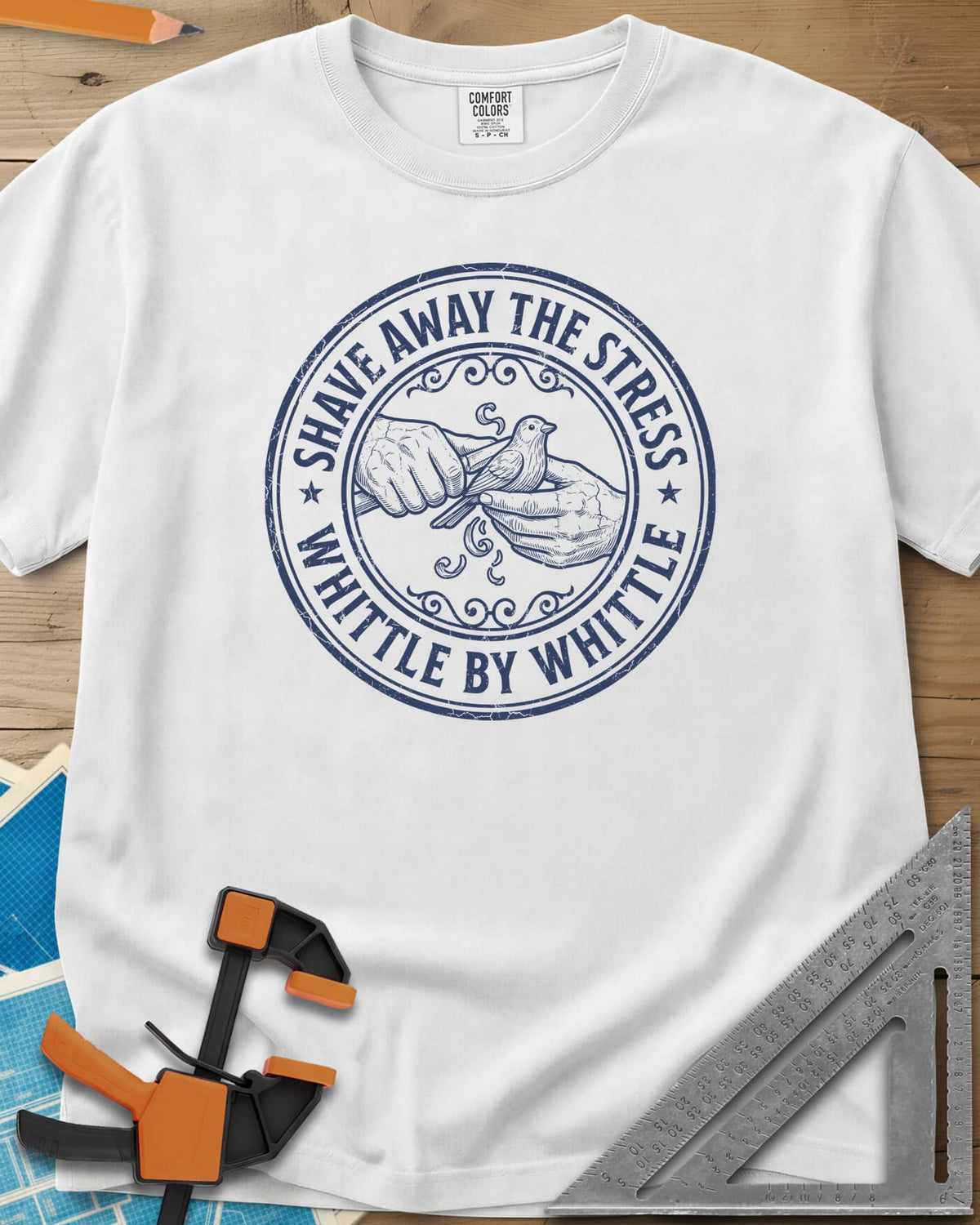 Whittle by Whittle heavyweight tee in White, two hands whittling a small bird inside a round distressed badge