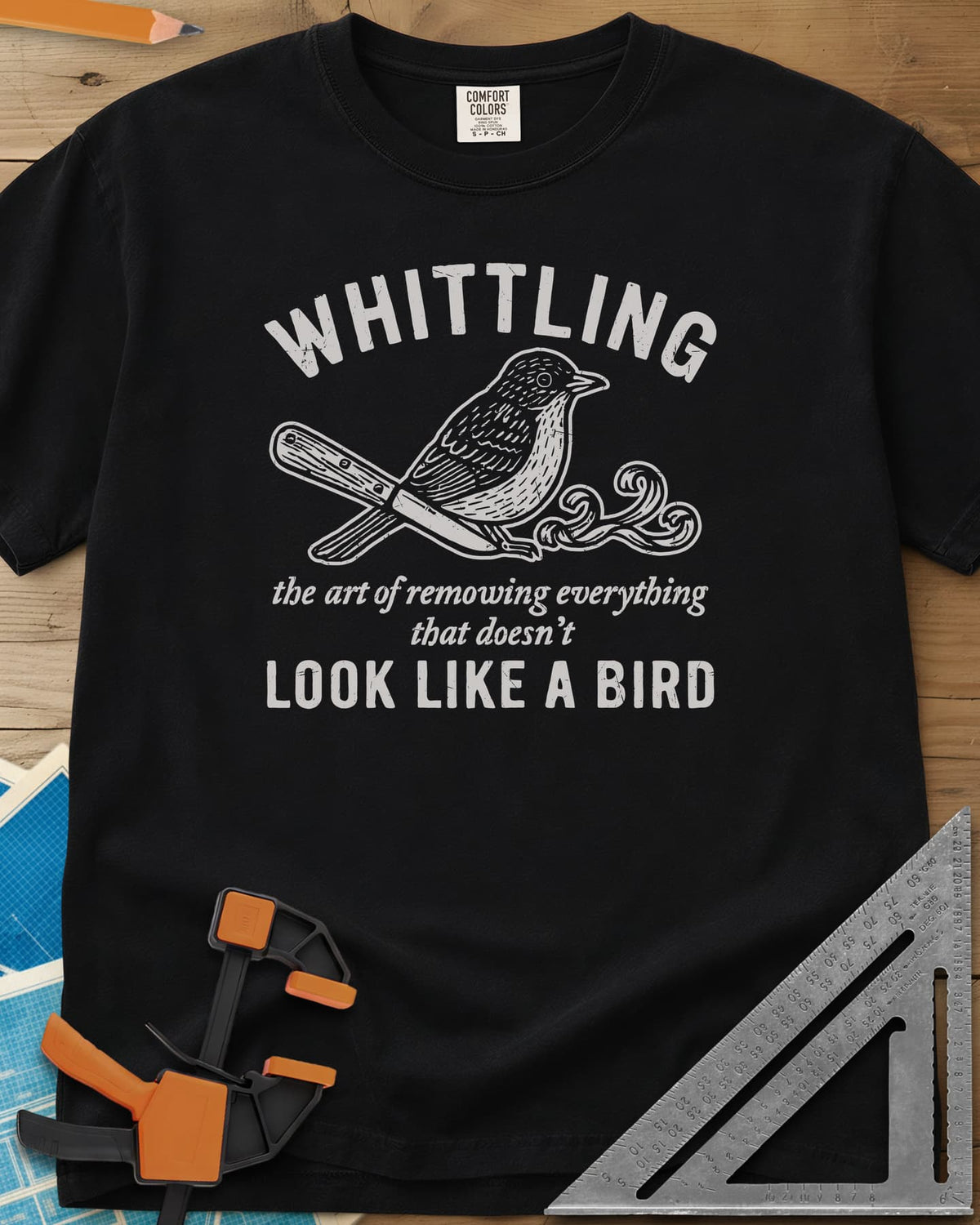 Whittling Art heavyweight tee in Black, an engraved songbird perched on a carving knife and wood curl