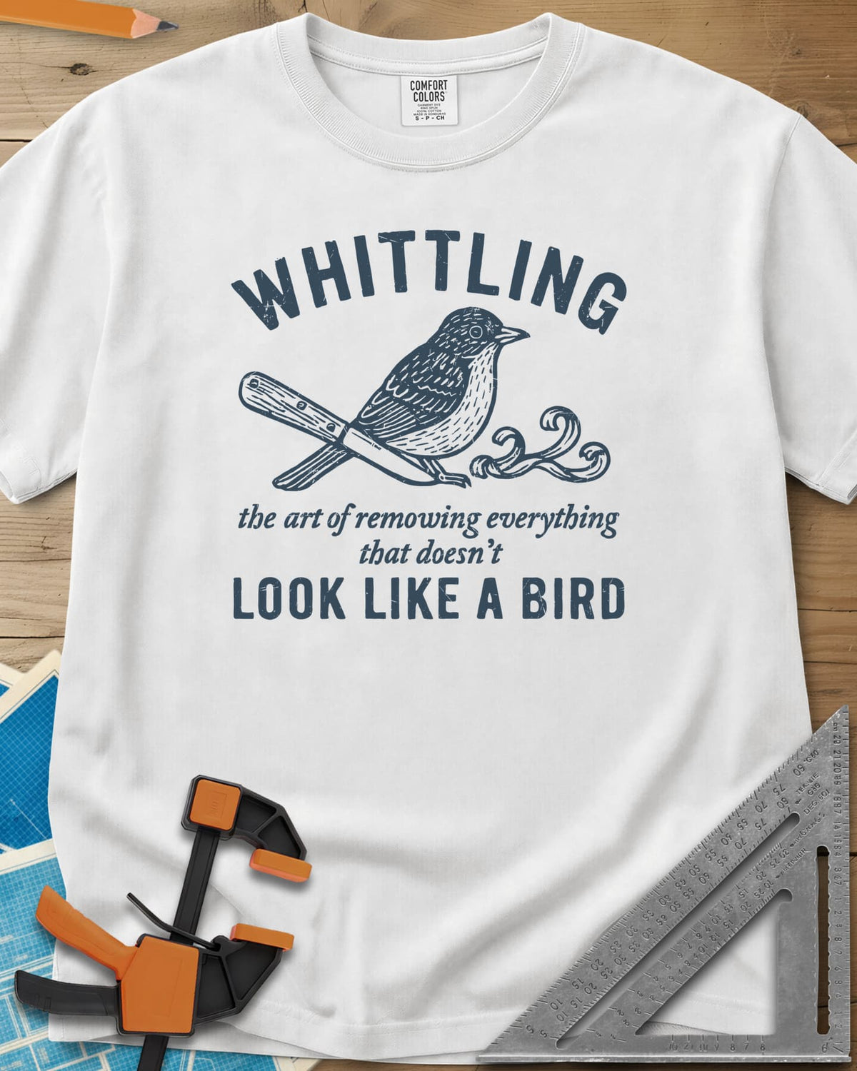 Whittling Art heavyweight tee in White, an engraved songbird perched on a carving knife and wood curl