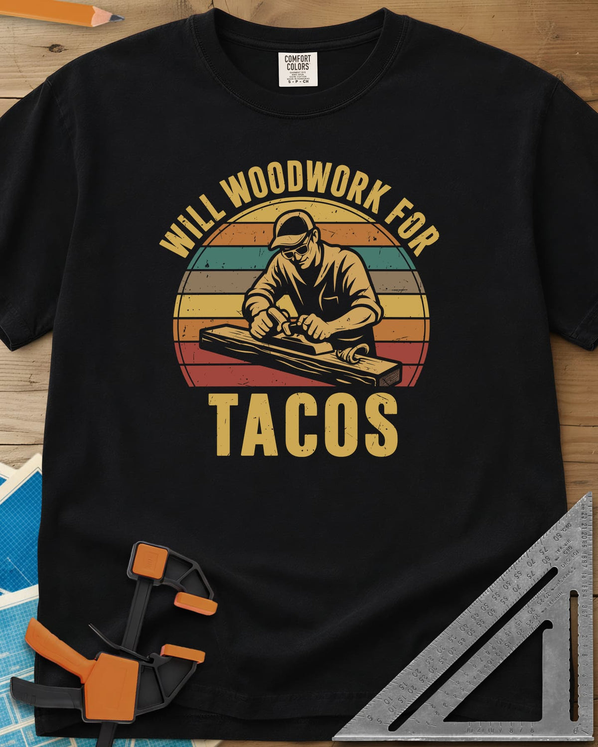 Will Woodwork For Tacos heavyweight tee in Black, a capped woodworker planing a board before retro sunset stripes