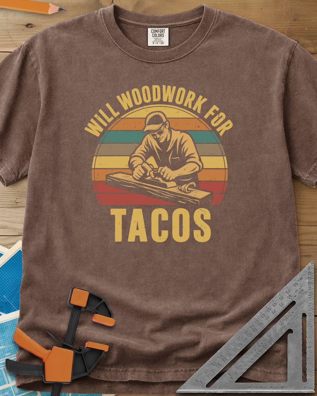 Will Woodwork For Tacos heavyweight tee in Espresso, a capped woodworker planing a board before retro sunset stripes