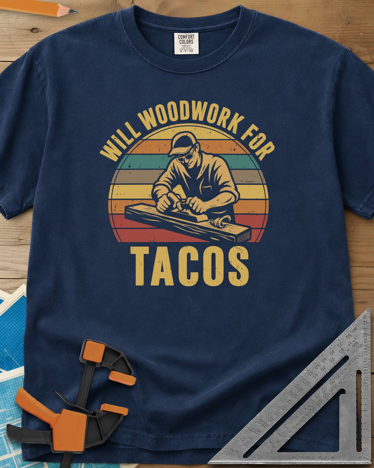Will Woodwork For Tacos heavyweight tee in Navy, a capped woodworker planing a board before retro sunset stripes
