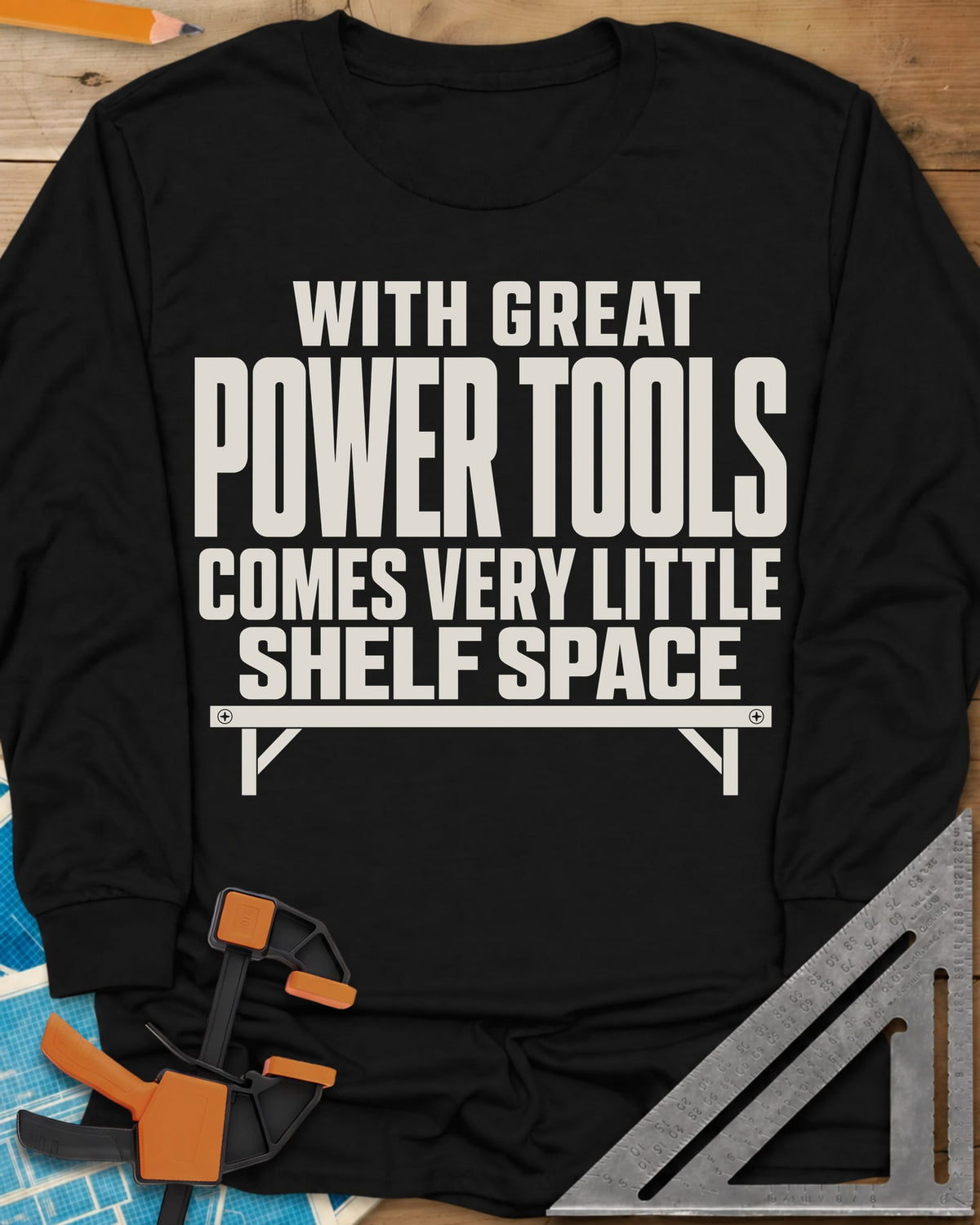 With Great Power Tools long sleeve shirt in Black, a bare wall shelf with brackets and screws under the slogan