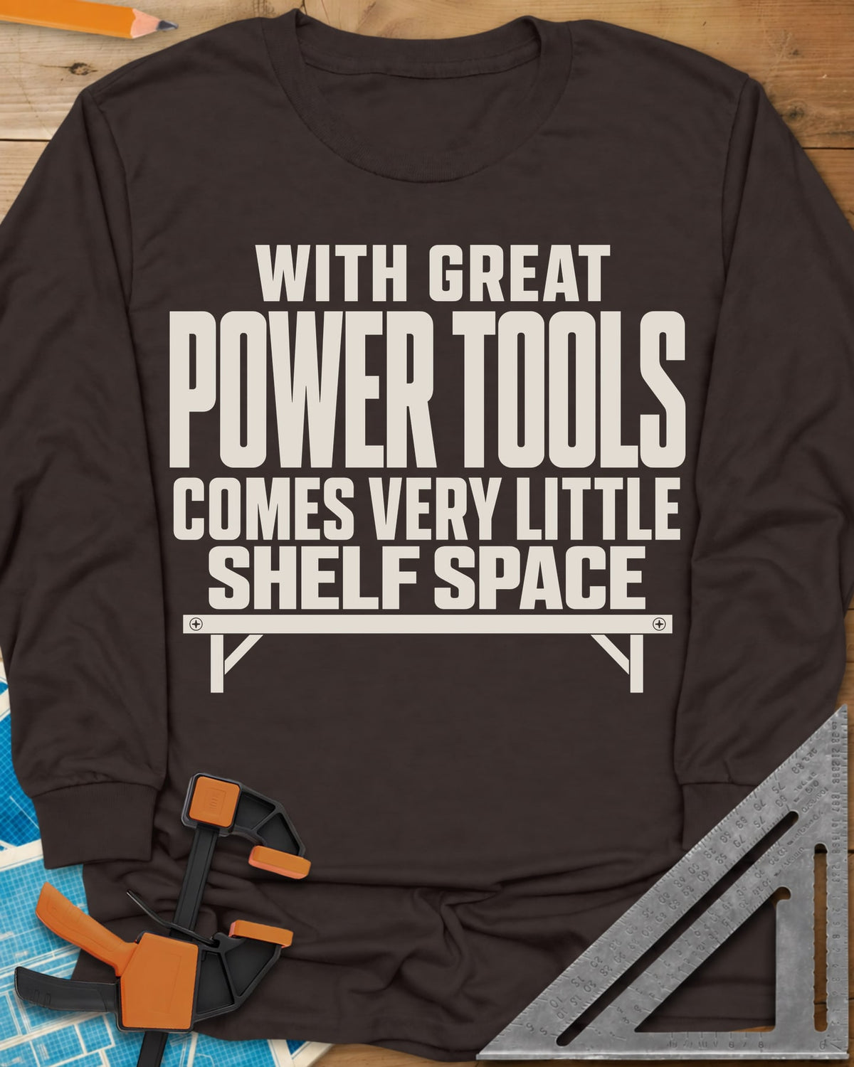 With Great Power Tools long sleeve shirt in Dark Chocolate, a bare wall shelf with brackets and screws under the slogan