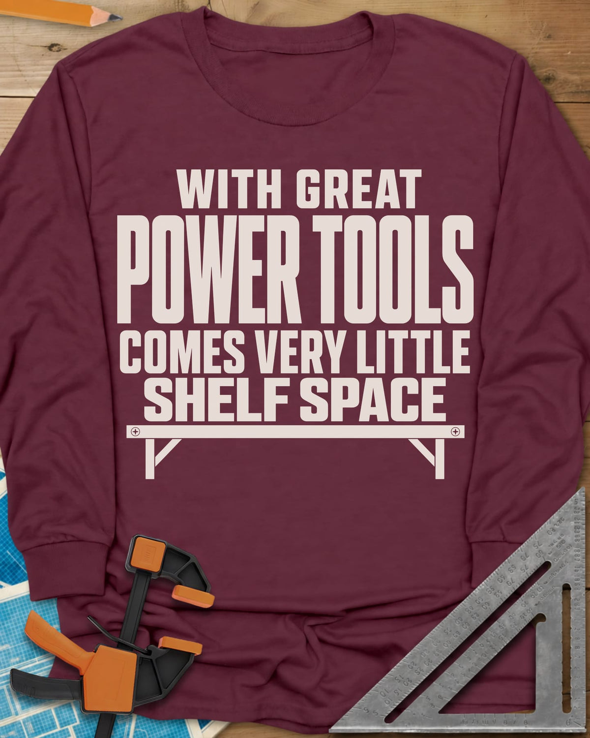 With Great Power Tools long sleeve shirt in Maroon, a bare wall shelf with brackets and screws under the slogan