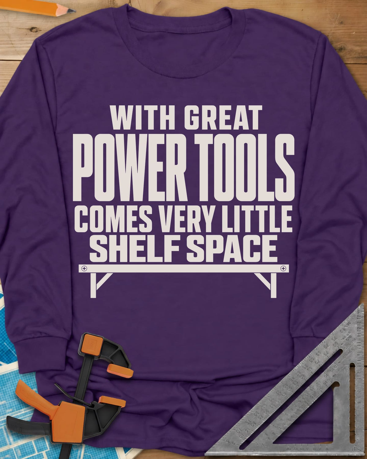 With Great Power Tools long sleeve shirt in Purple, a bare wall shelf with brackets and screws under the slogan