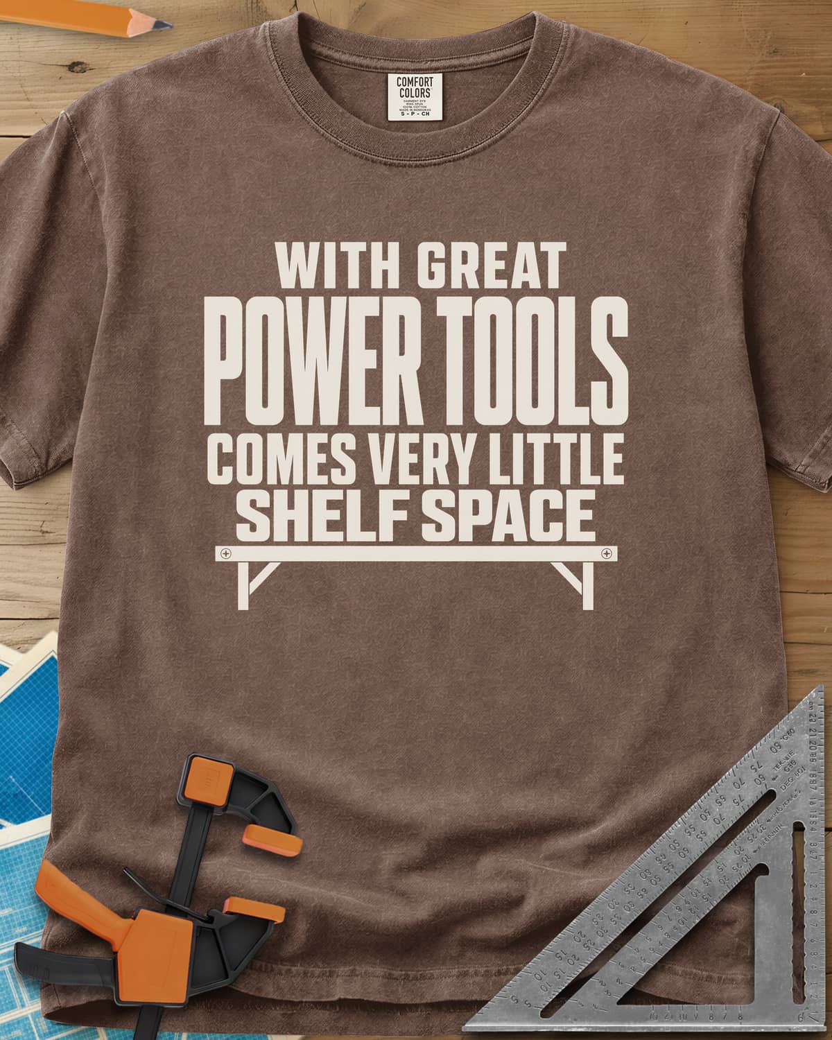 With Great Power Tools heavyweight tee in Espresso, a bare wall shelf with brackets and screws under the slogan