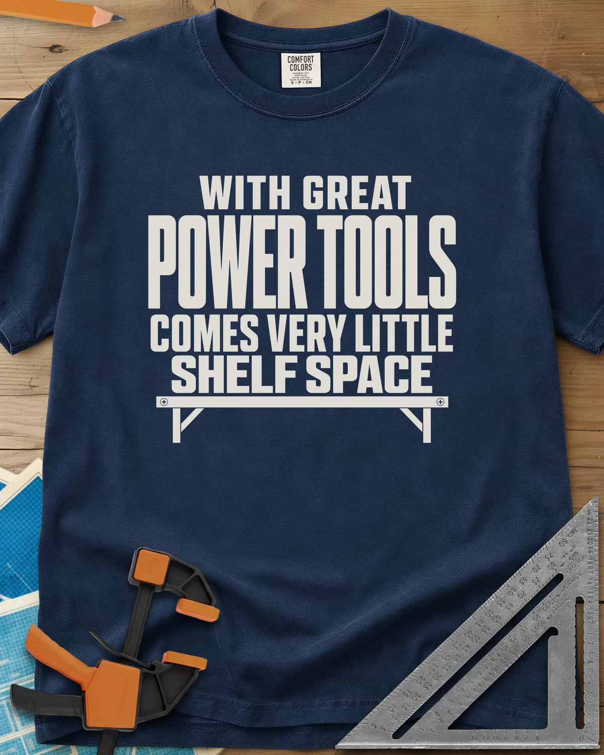 With Great Power Tools heavyweight tee in Navy, a bare wall shelf with brackets and screws under the slogan