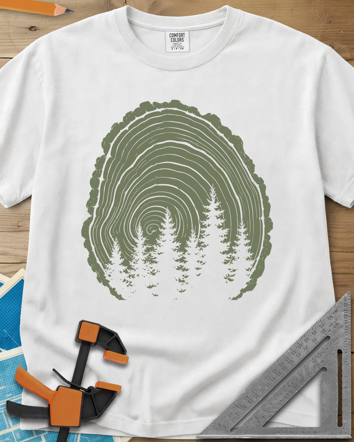 Wood Grain Forest heavyweight tee in White, cut log tree rings with a stand of pine trees inside