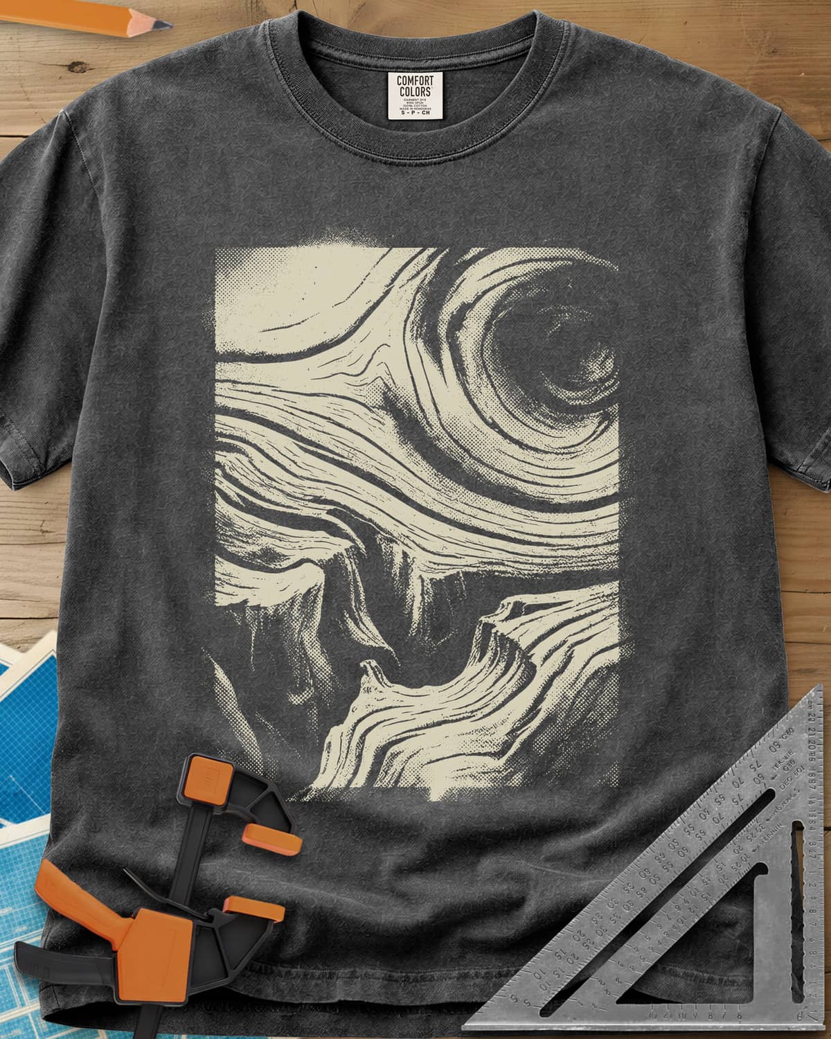 Wood Grain Skull heavyweight tee in Pepper, a skull hiding in swirling halftone wood grain