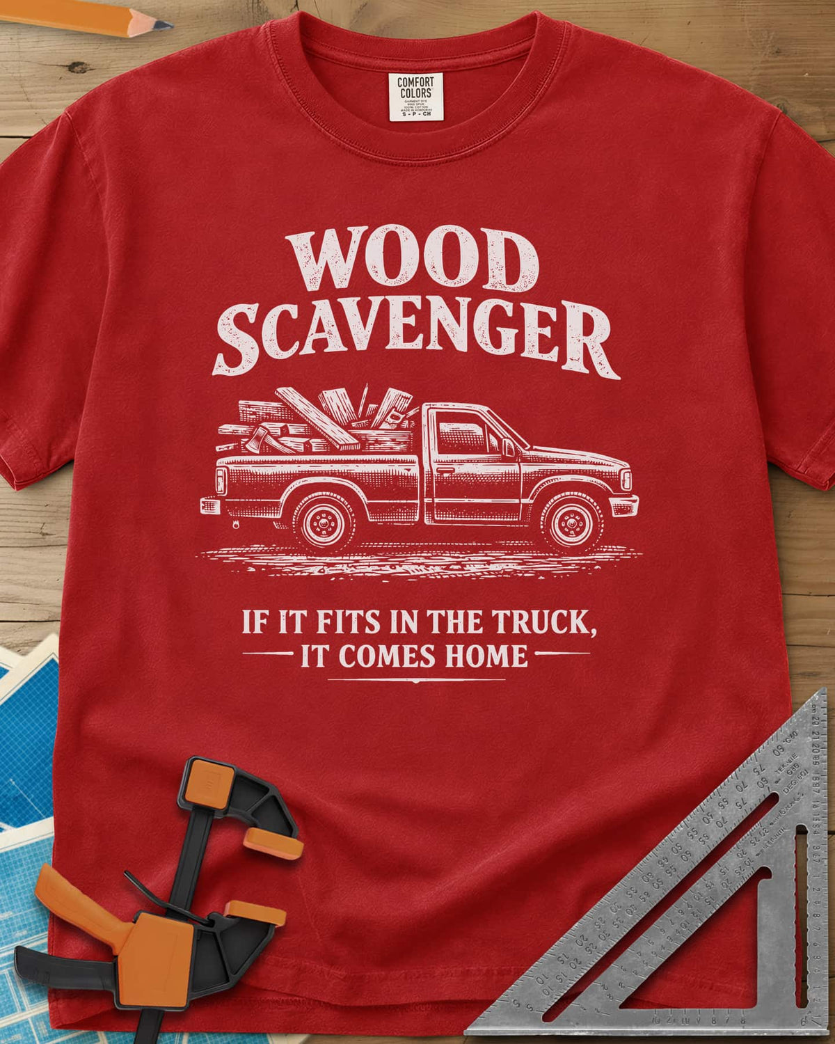 Wood Scavenger heavyweight tee in Red, a pickup truck loaded with boards, offcuts and an axe