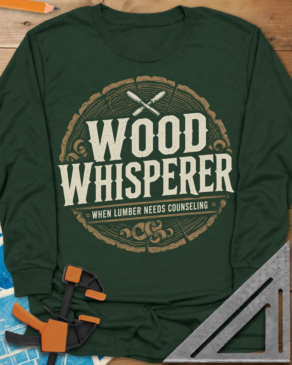 Wood Whisperer long sleeve shirt in Forest Green, a round log-slice badge with crossed chisels and shaving curls
