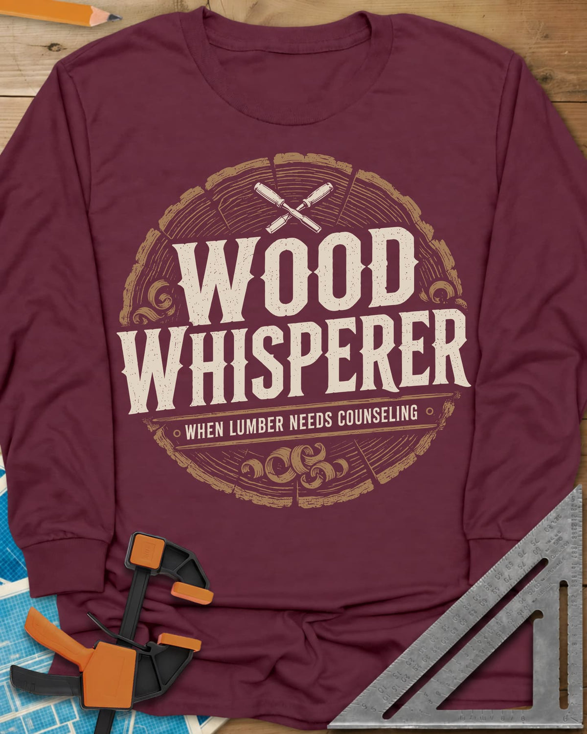 Wood Whisperer long sleeve shirt in Maroon, a round log-slice badge with crossed chisels and shaving curls