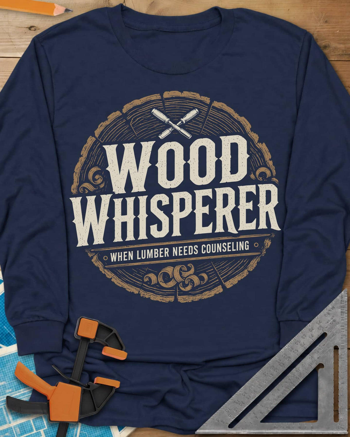 Wood Whisperer long sleeve shirt in Navy, a round log-slice badge with crossed chisels and shaving curls