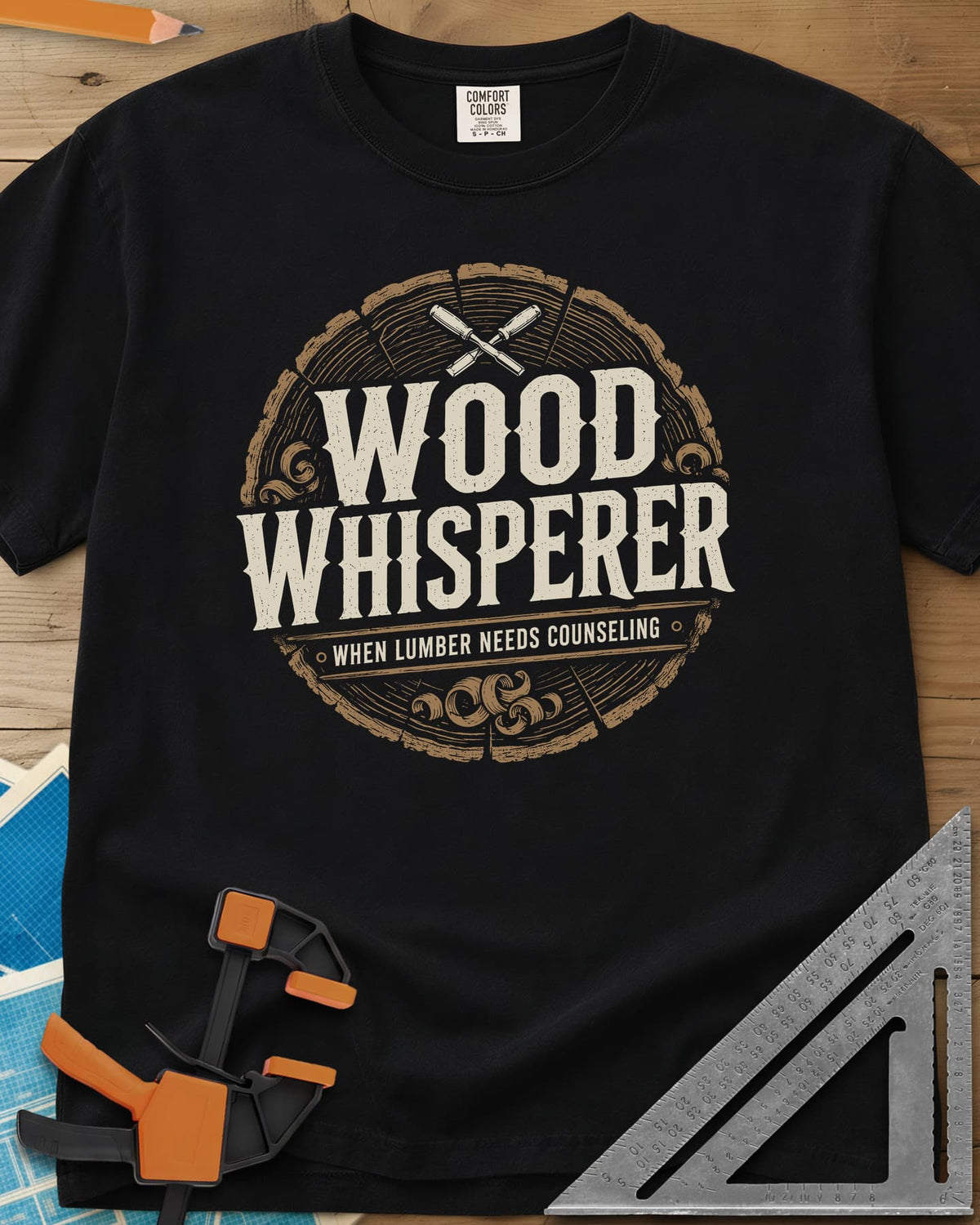Wood Whisperer heavyweight tee in Black, a round log-slice badge with crossed chisels and shaving curls