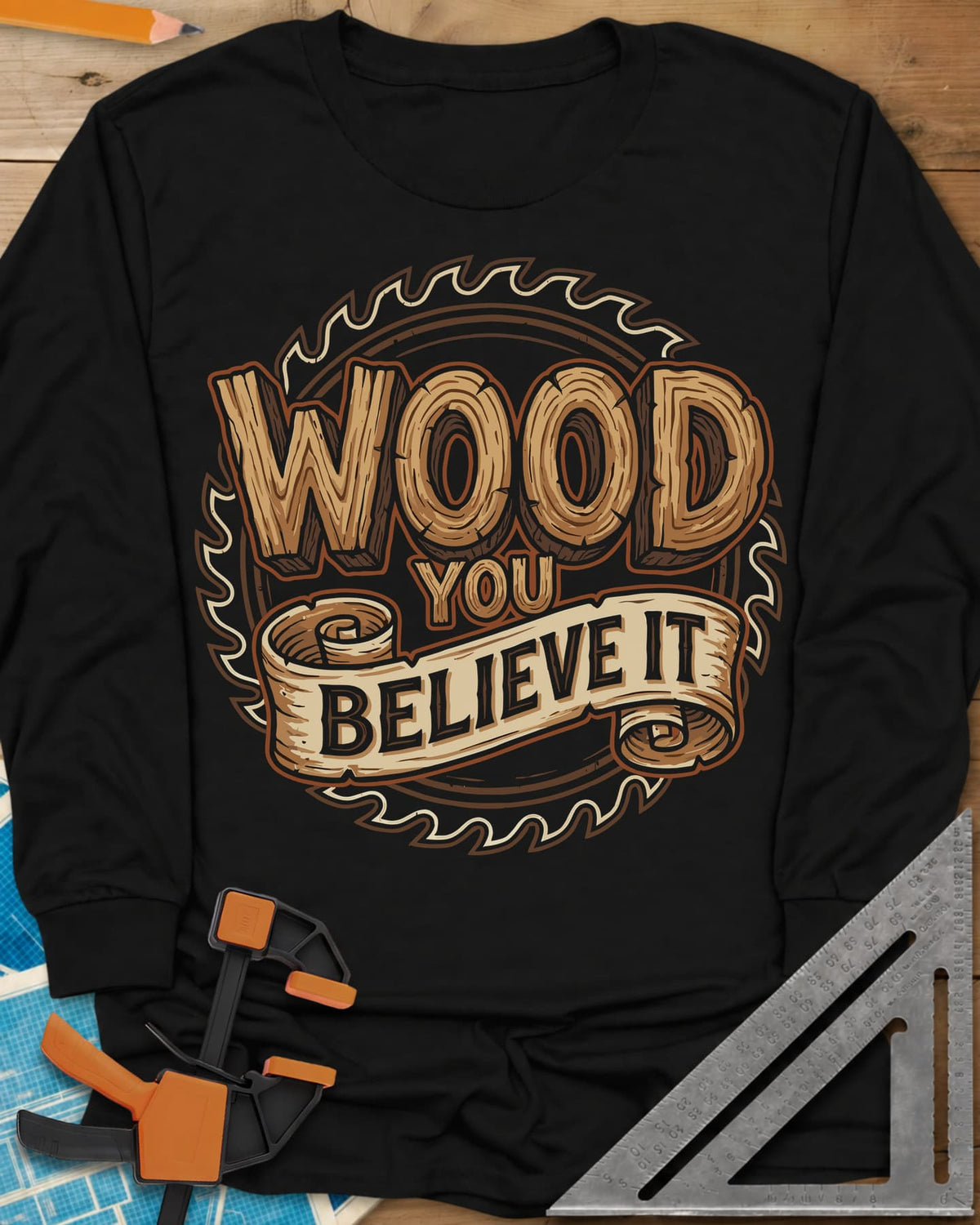 Wood You Believe long sleeve shirt in Black, wood-grain letters on a scroll banner over a circular saw blade
