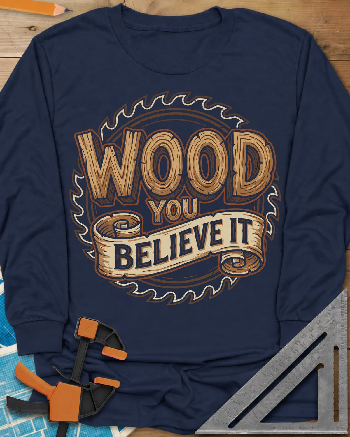 Wood You Believe long sleeve shirt in Navy, wood-grain letters on a scroll banner over a circular saw blade