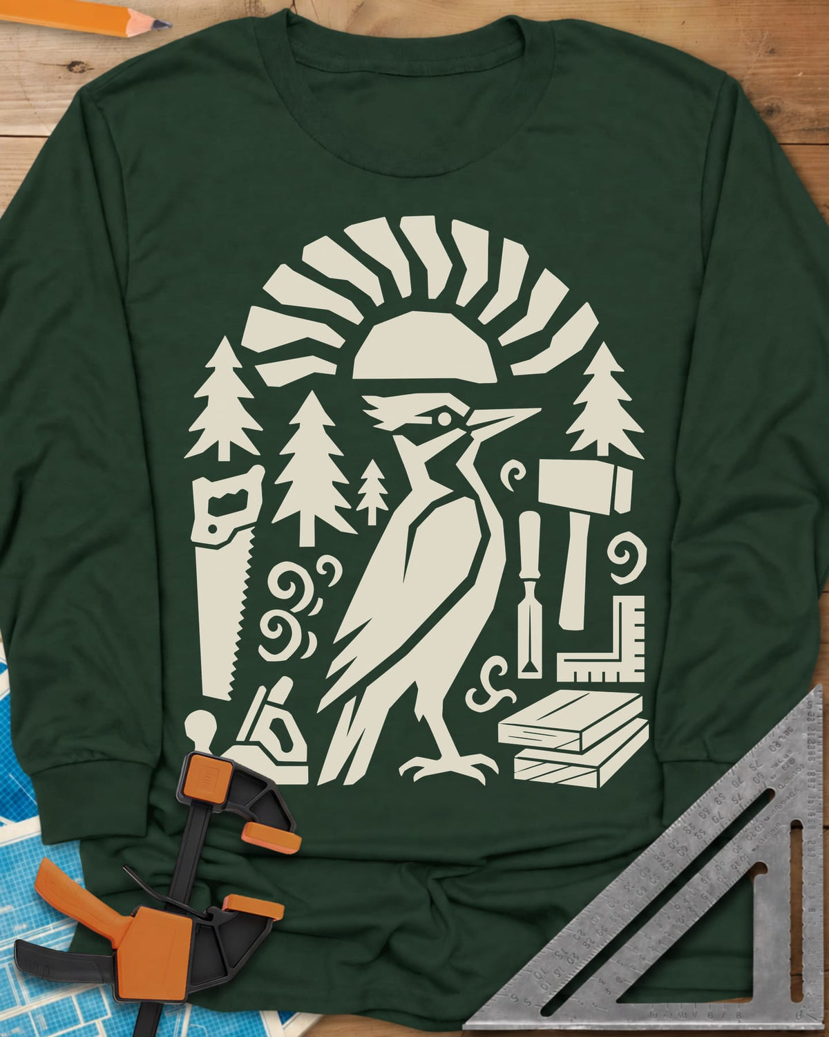 Woodpecker Craft long sleeve shirt in Forest Green, a geometric woodpecker among saws, planes, chisels and pine trees