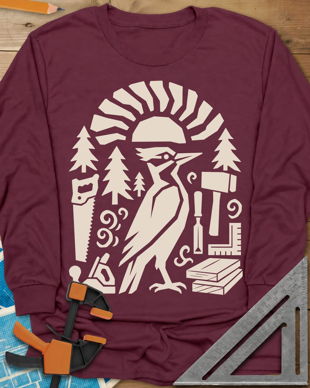 Woodpecker Craft long sleeve shirt in Maroon, a geometric woodpecker among saws, planes, chisels and pine trees