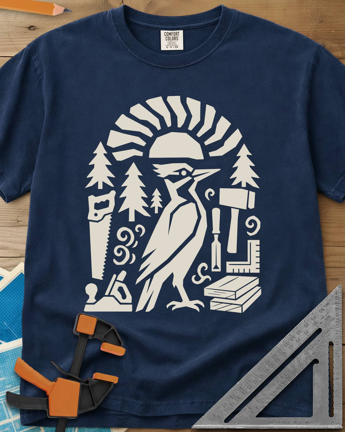Woodpecker Craft heavyweight tee in Navy, a geometric woodpecker among saws, planes, chisels and pine trees