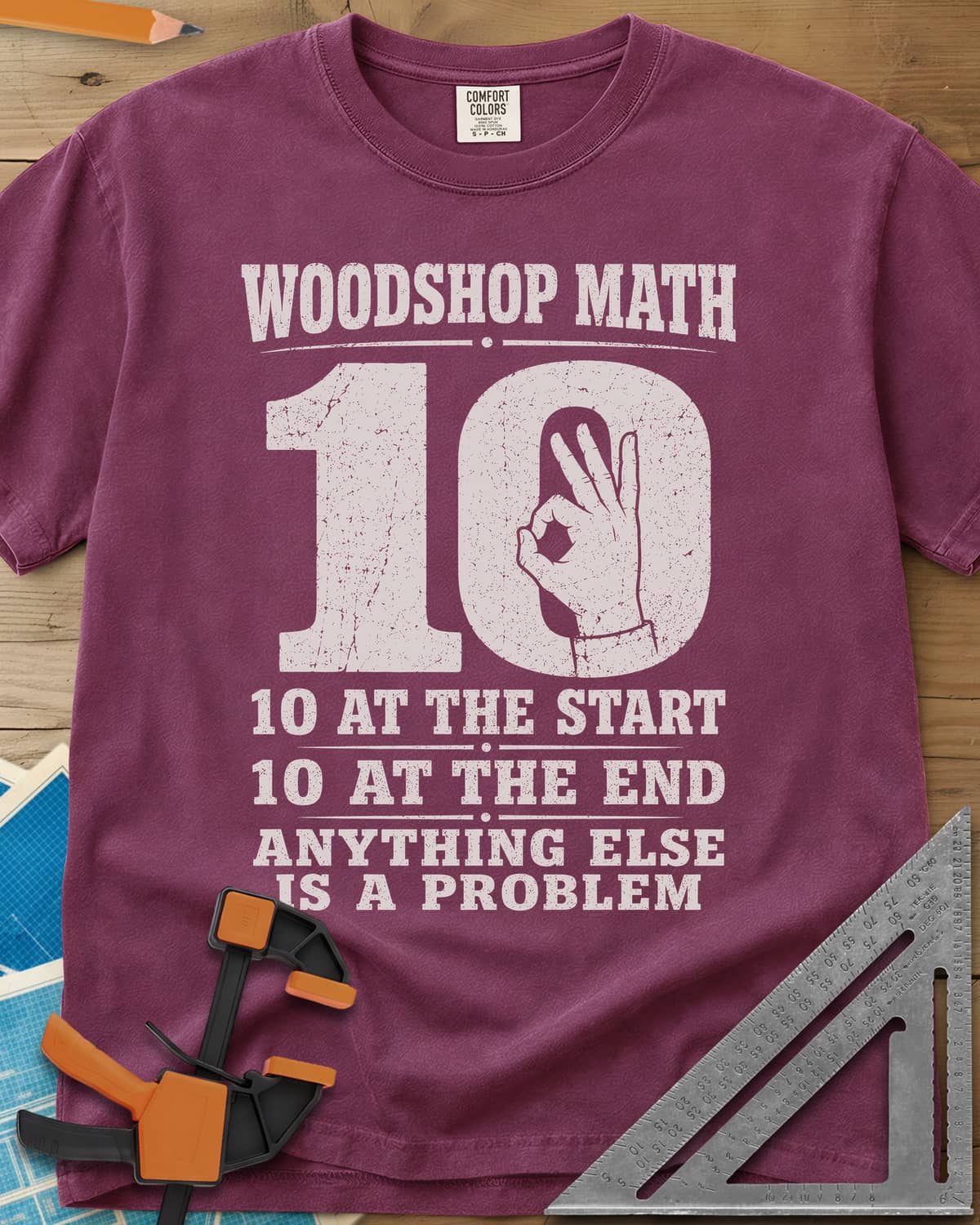 Woodshop Math heavyweight tee in Berry, a big worn 10 with an OK-sign hand inside the zero