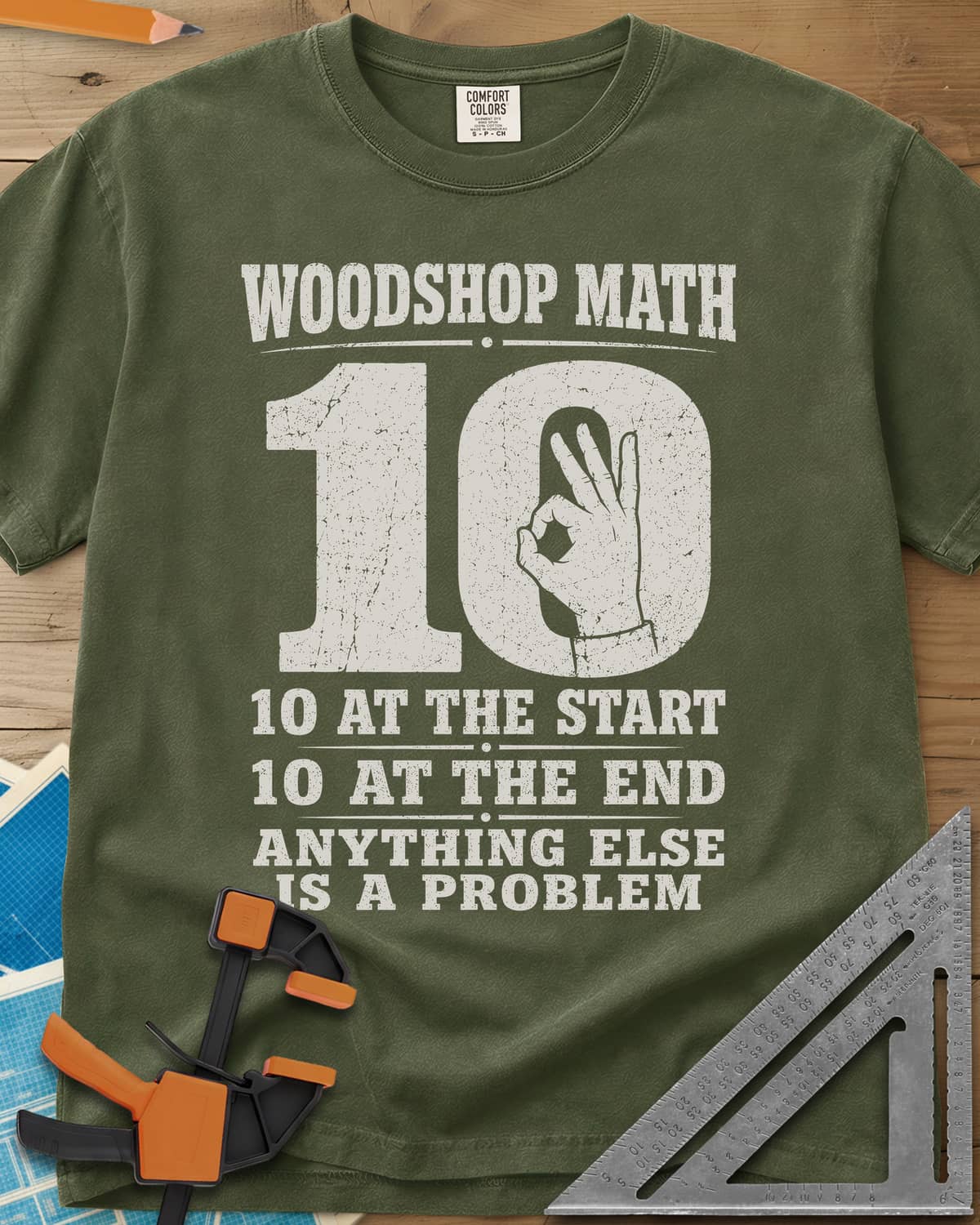 Woodshop Math heavyweight tee in Hemp, a big worn 10 with an OK-sign hand inside the zero