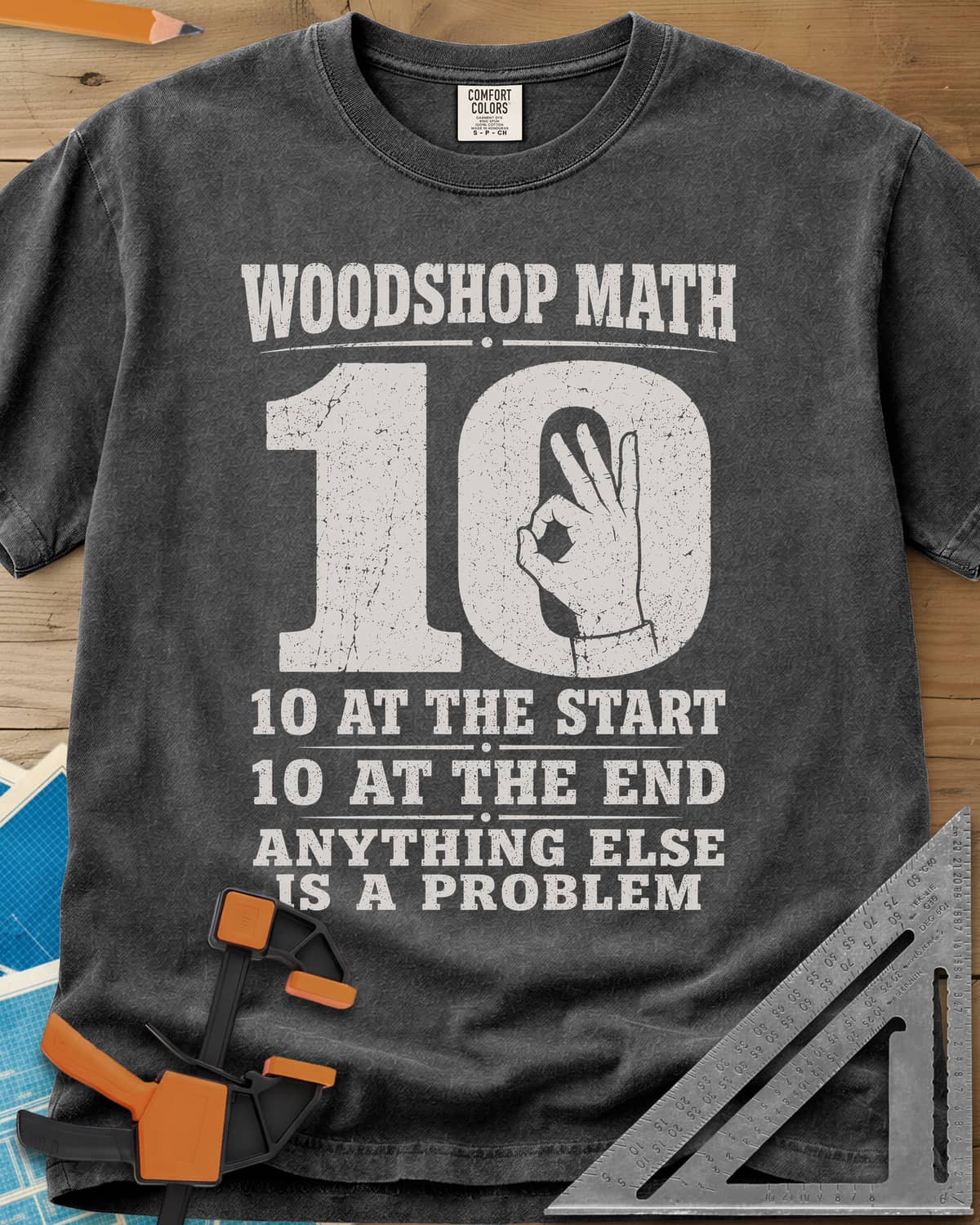 Woodshop Math heavyweight tee in Pepper, a big worn 10 with an OK-sign hand inside the zero