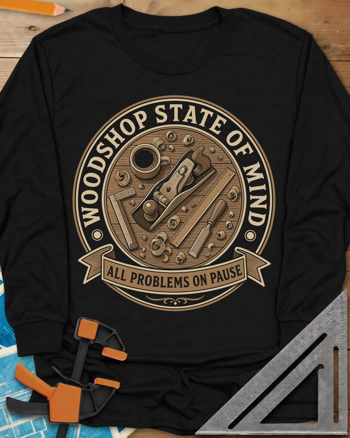 Woodshop State Of Mind long sleeve shirt in Black, a round badge of a hand plane, coffee, chisel and shavings on a bench