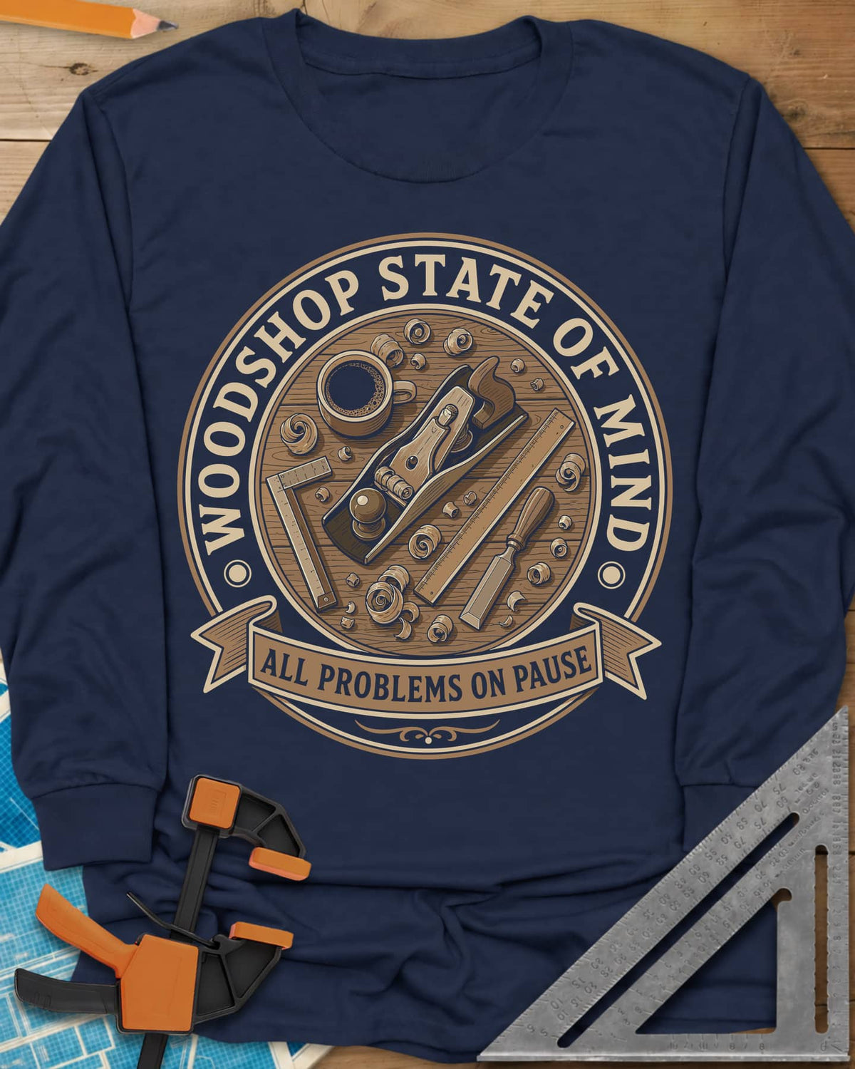 Woodshop State Of Mind long sleeve shirt in Navy, a round badge of a hand plane, coffee, chisel and shavings on a bench