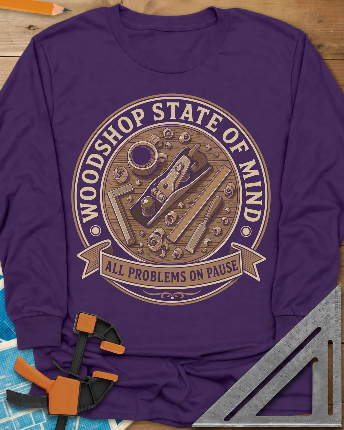 Woodshop State Of Mind long sleeve shirt in Purple, a round badge of a hand plane, coffee, chisel and shavings on a bench