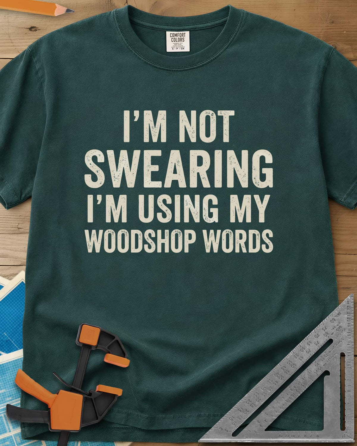 Woodshop Words heavyweight tee in Blue Spruce, distressed all-caps lettering, no graphics