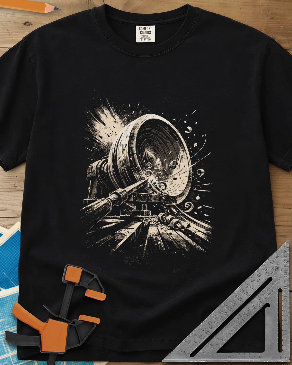 Woodturning Fury heavyweight tee in Black, a wood lathe mid-cut with shavings and chips flying