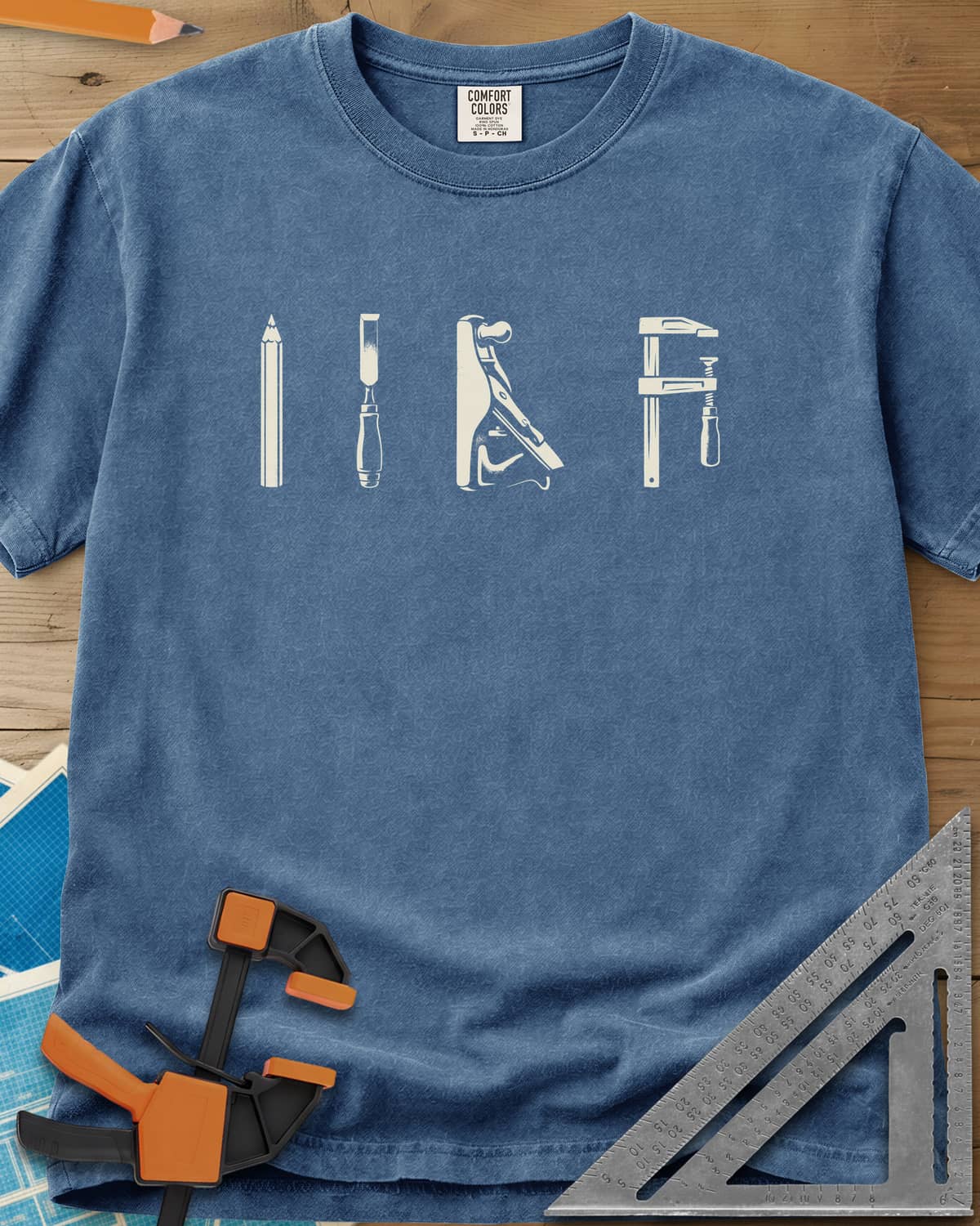 Woodworker Arsenal heavyweight tee in Blue Jean, four tools in a row: pencil, chisel, hand plane, bar clamp