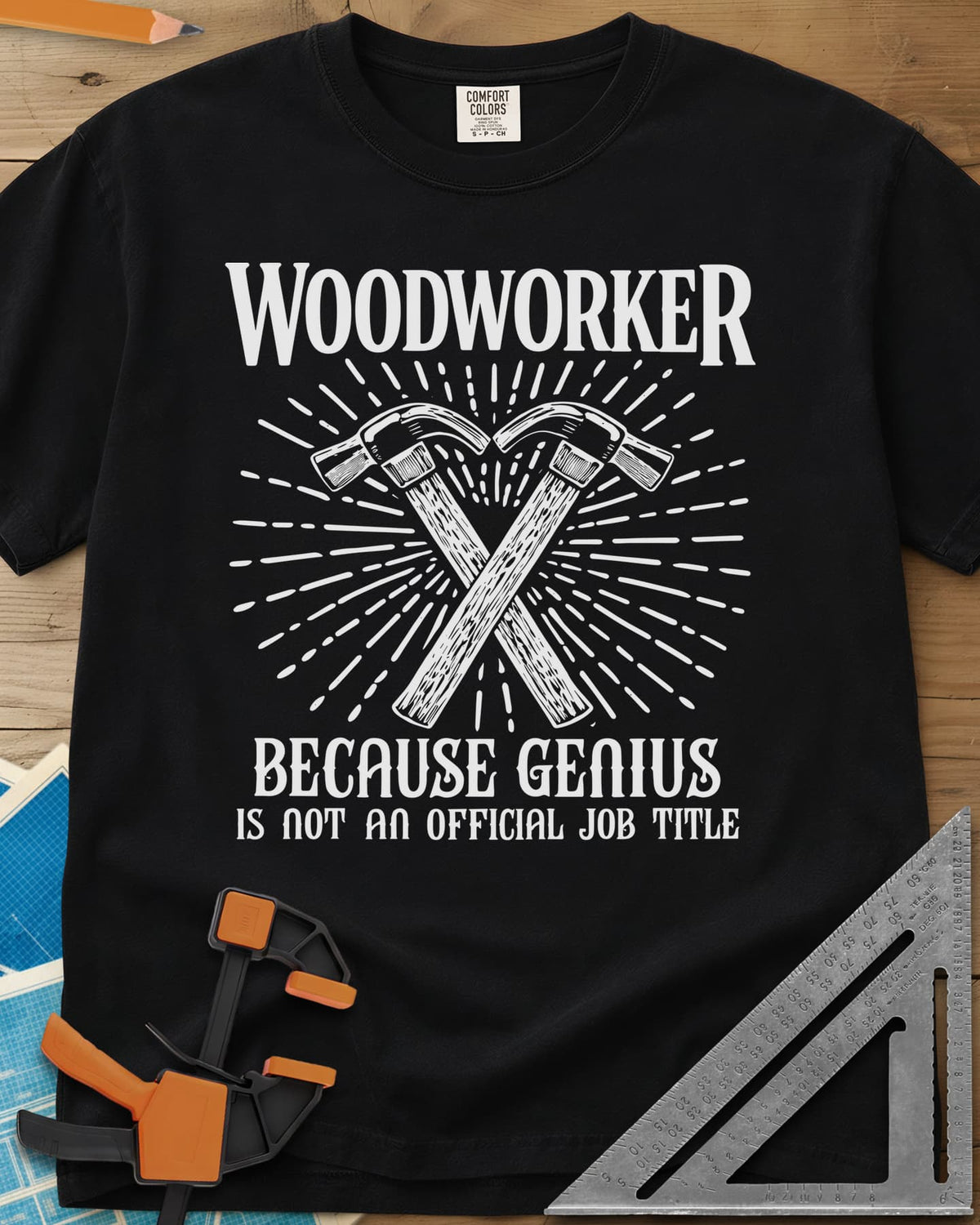 Woodworker Because Genius heavyweight tee in Black, two crossed hammers inside a sunburst of fine lines