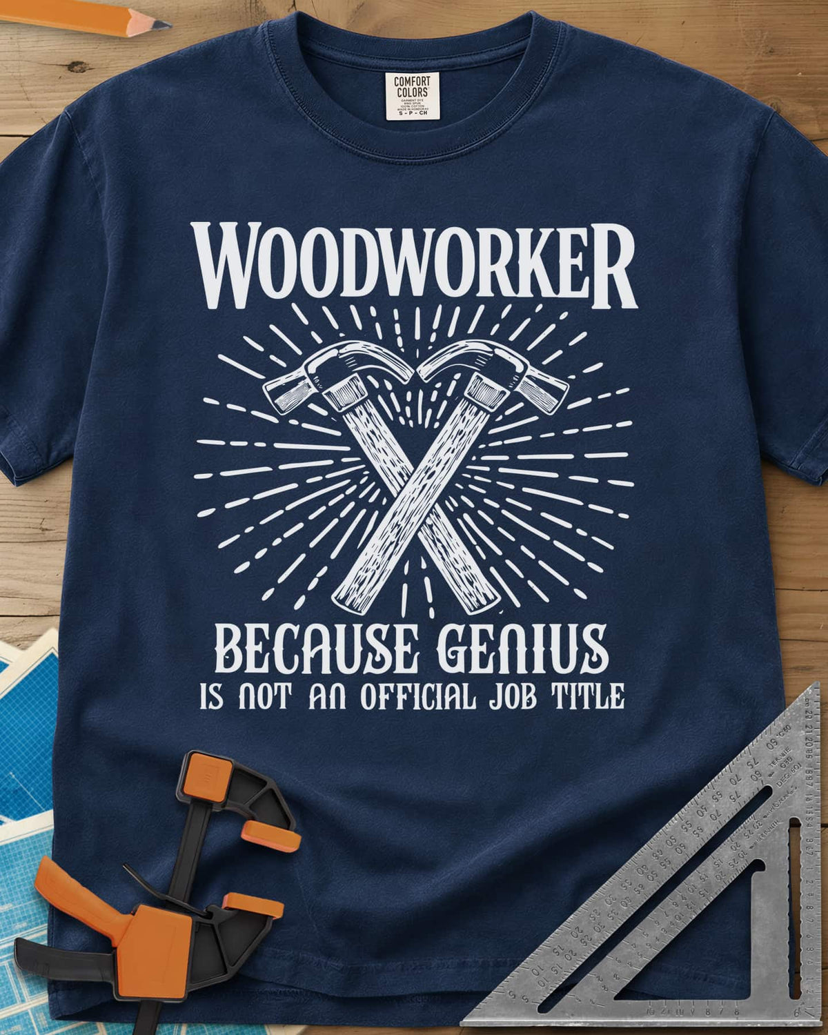 Woodworker Because Genius heavyweight tee in Navy, two crossed hammers inside a sunburst of fine lines