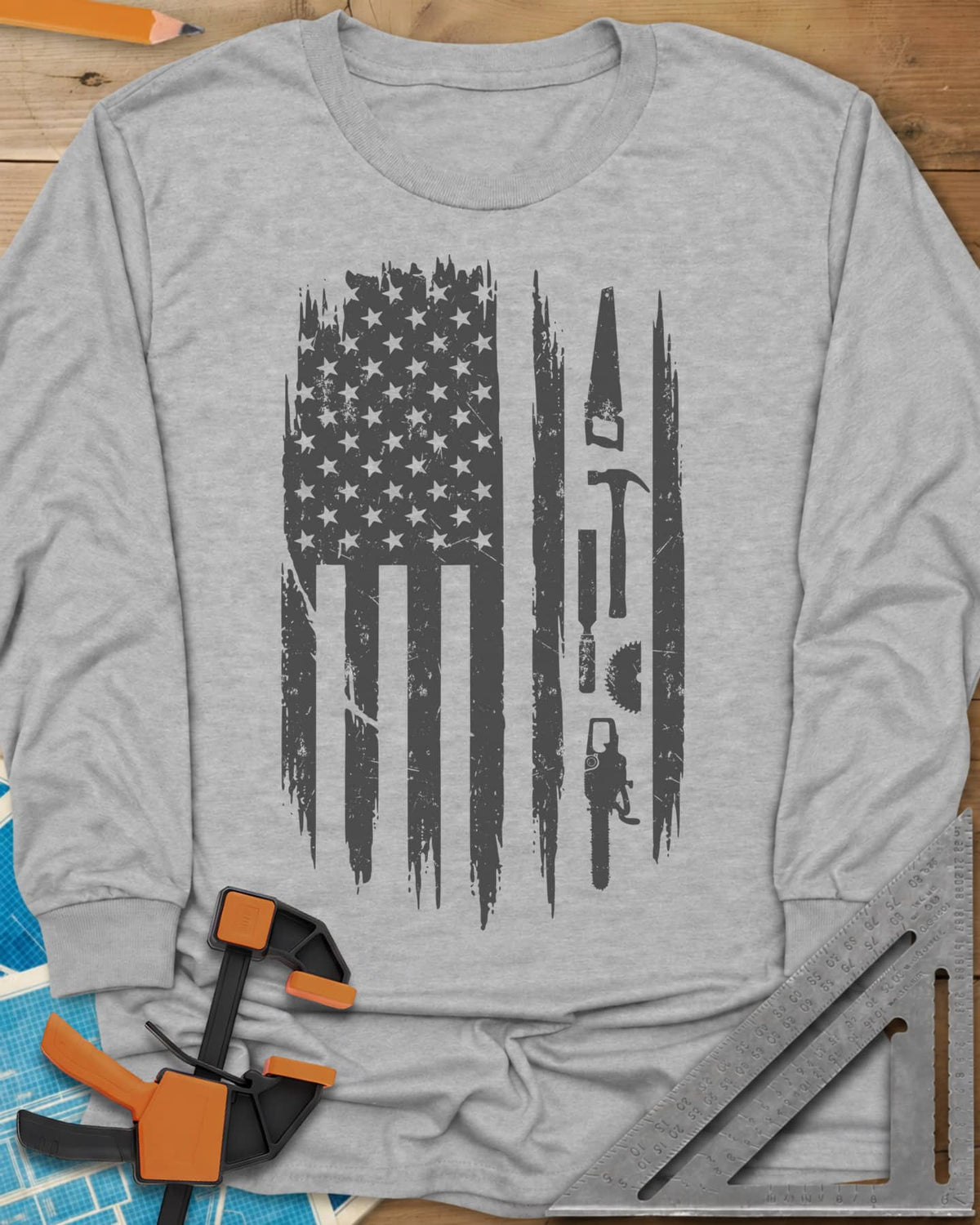 Woodworker Flag long sleeve shirt in Sport Grey, a distressed American flag with a hand saw, hammer and chainsaw