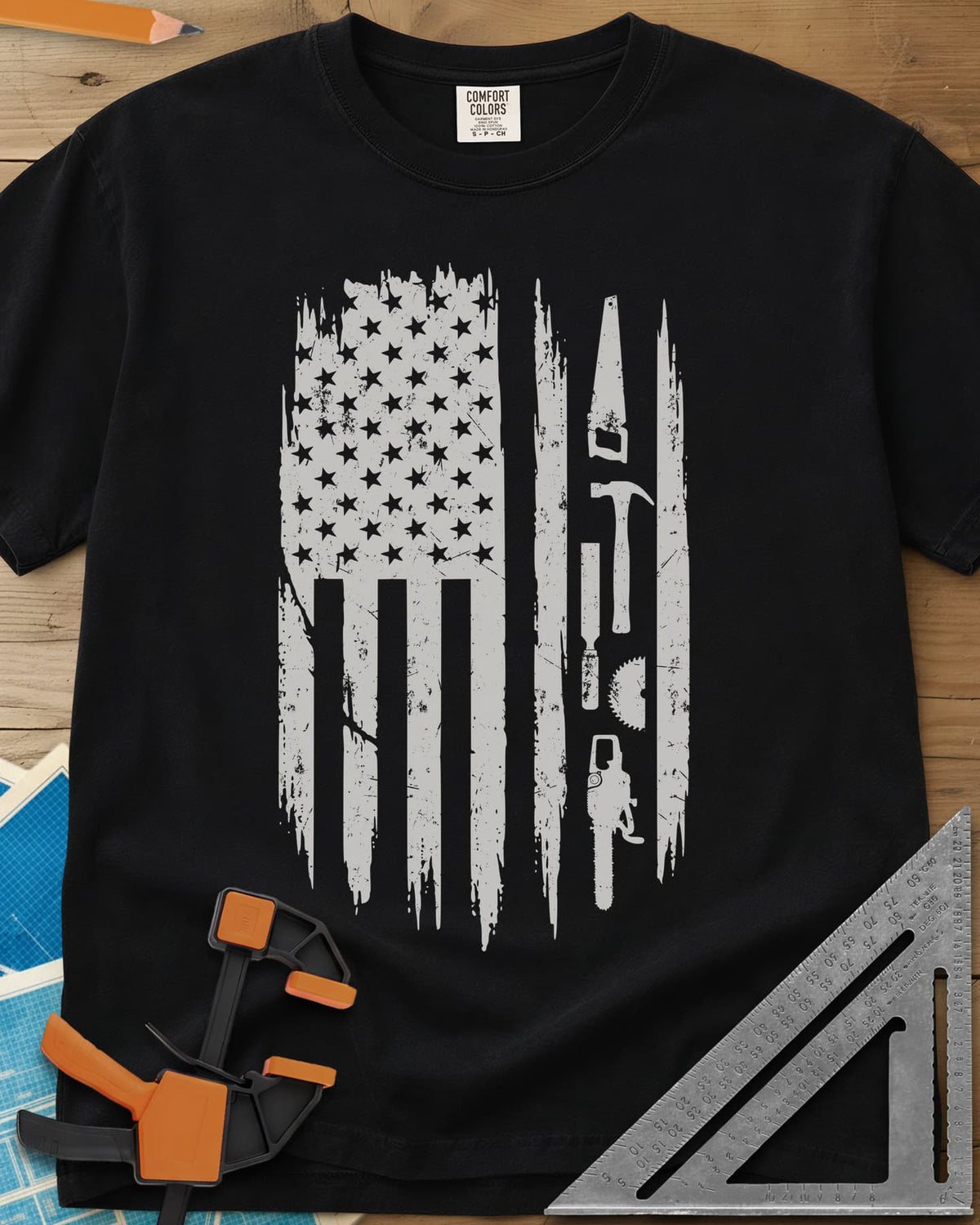 Woodworker Flag heavyweight tee in Black, a distressed American flag with a hand saw, hammer and chainsaw