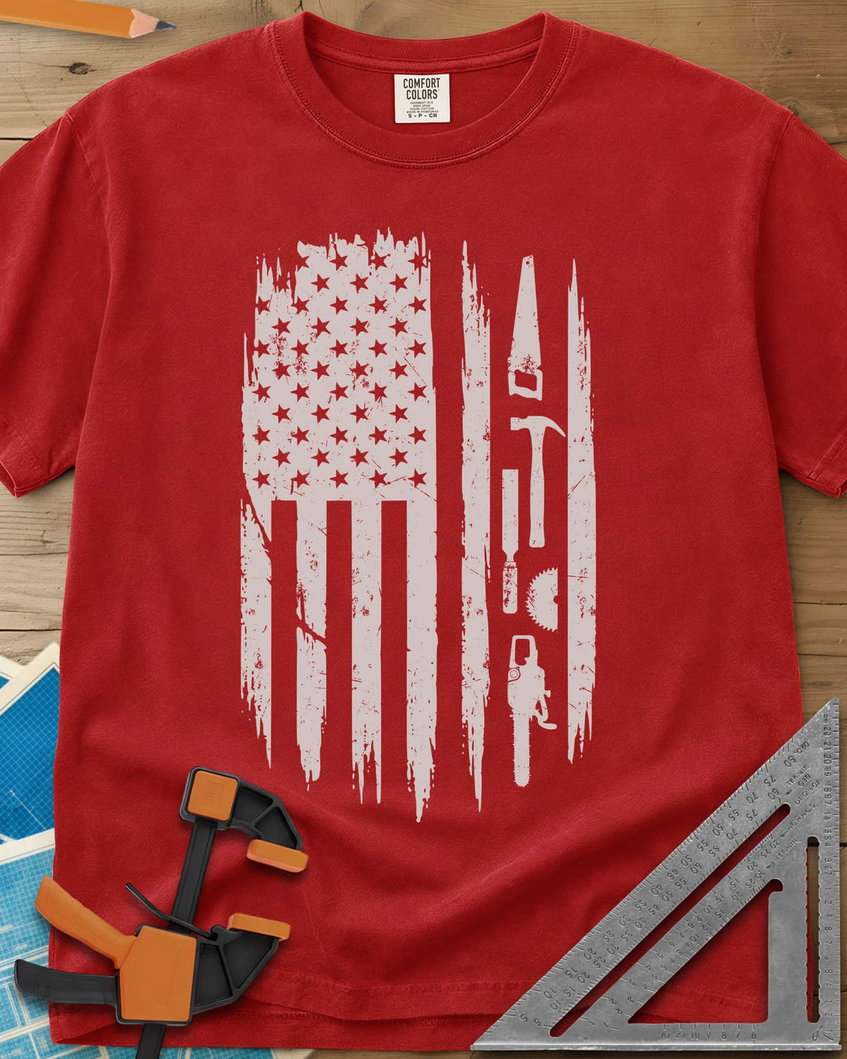Woodworker Flag heavyweight tee in Red, a distressed American flag with a hand saw, hammer and chainsaw