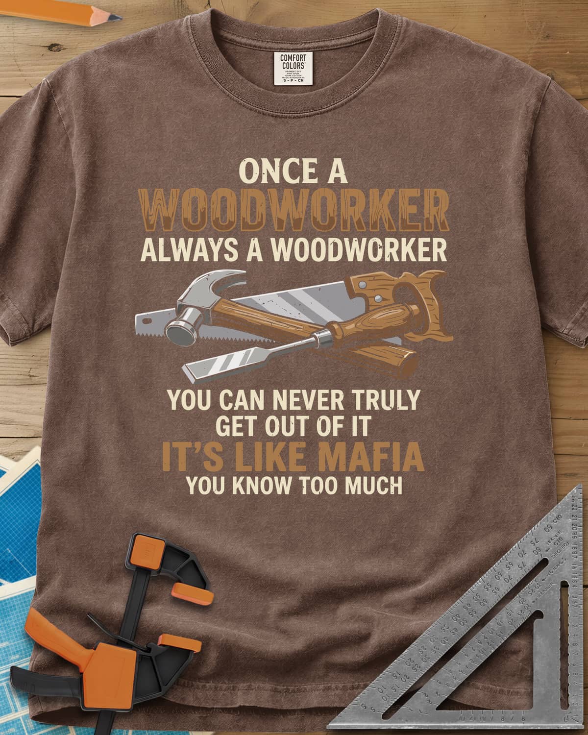 Woodworker For Life heavyweight tee in Espresso, a claw hammer, hand saw and chisel crossed in the middle