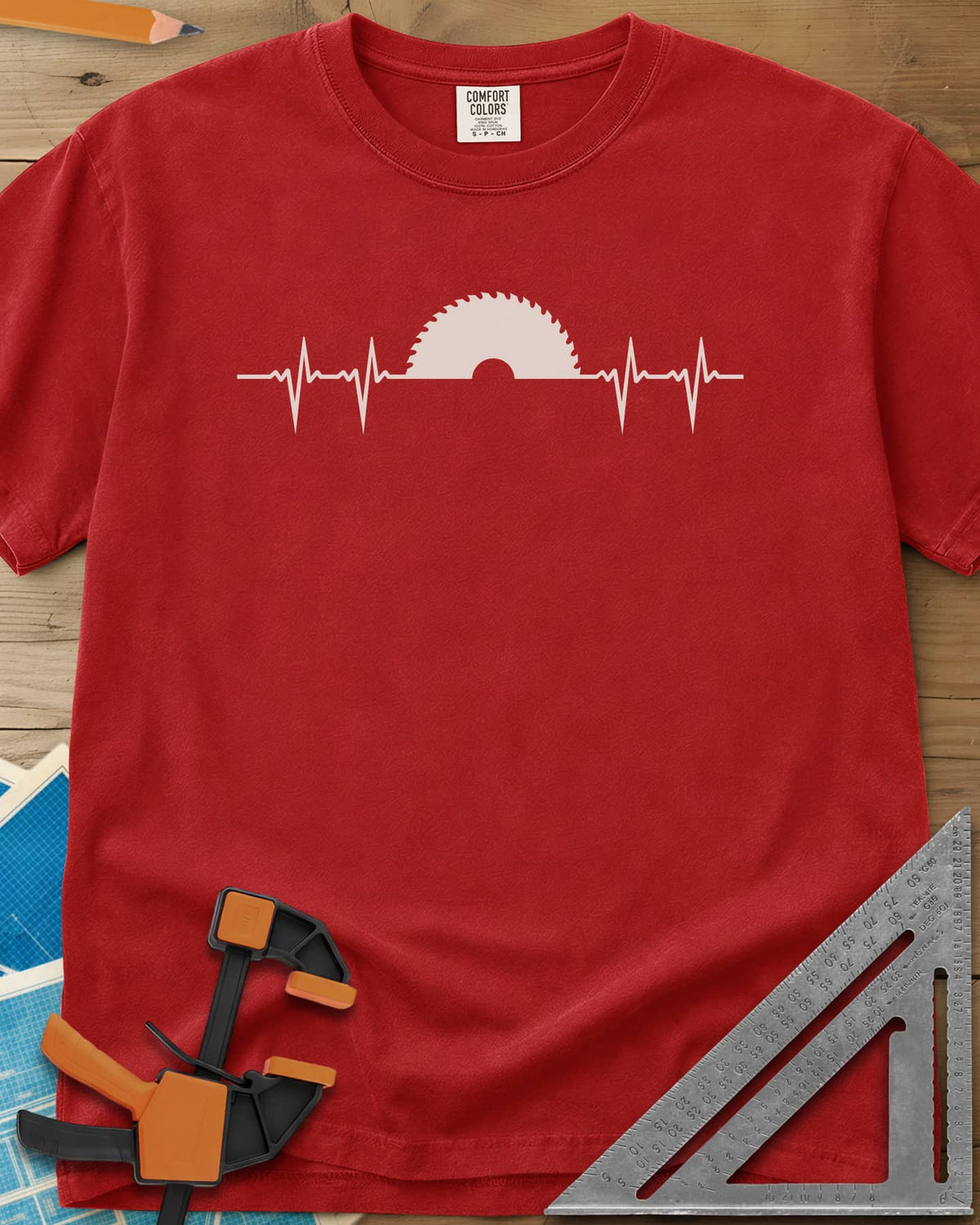 Woodworker Heartbeat heavyweight tee in Red, a heartbeat line rising into a half saw blade