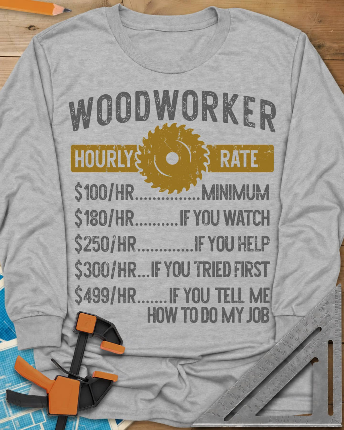 Woodworker Hourly Rate long sleeve shirt in Sport Grey, a rate sheet with a gold saw blade banner and gag hourly tiers
